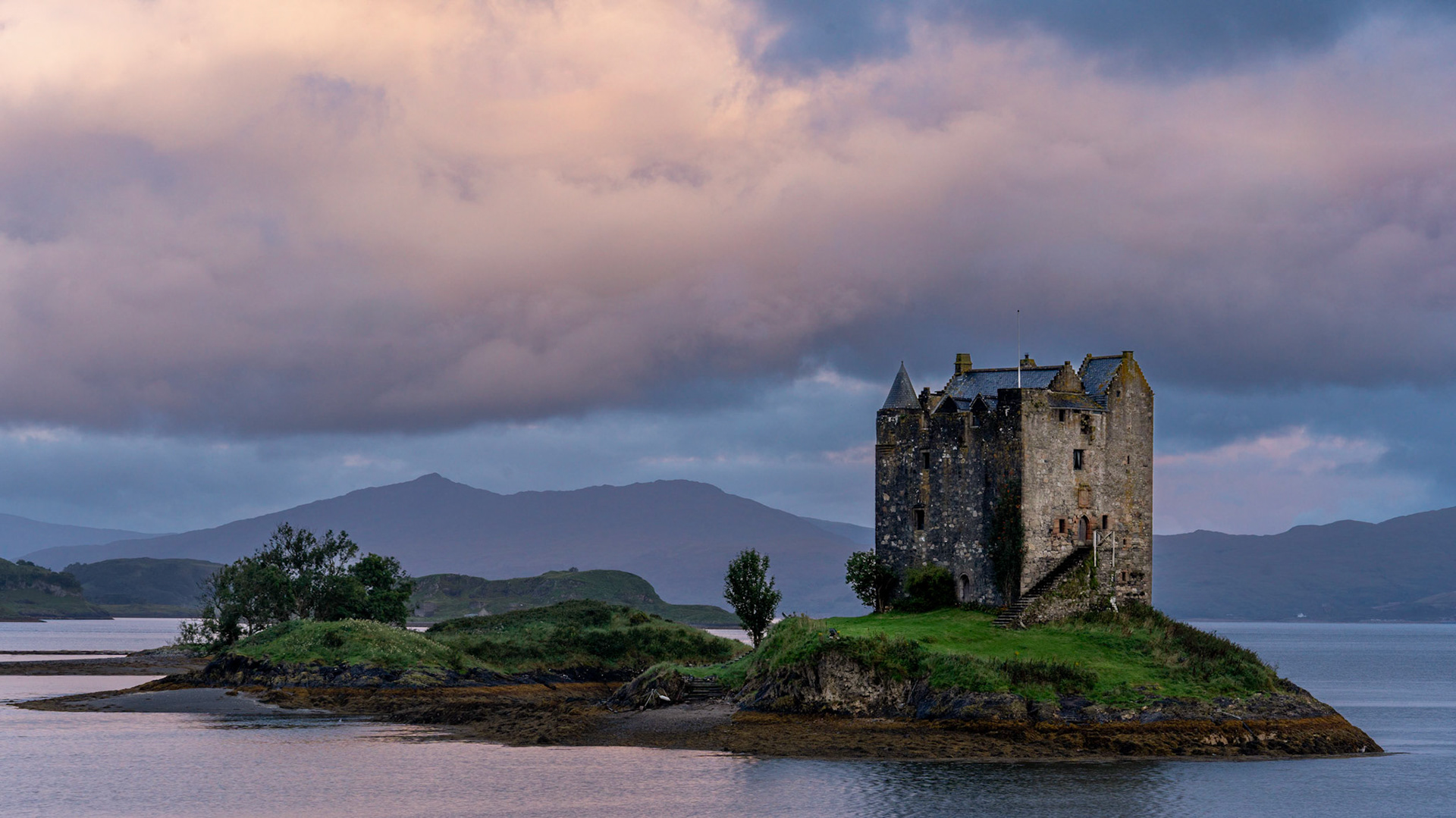 Castle Stalker on the West Coast of Scotland is well known as the castle used in Monty Python's Holy Grail. Getting early morning light is on the castle is difficult as it's shaded by hills to the East.