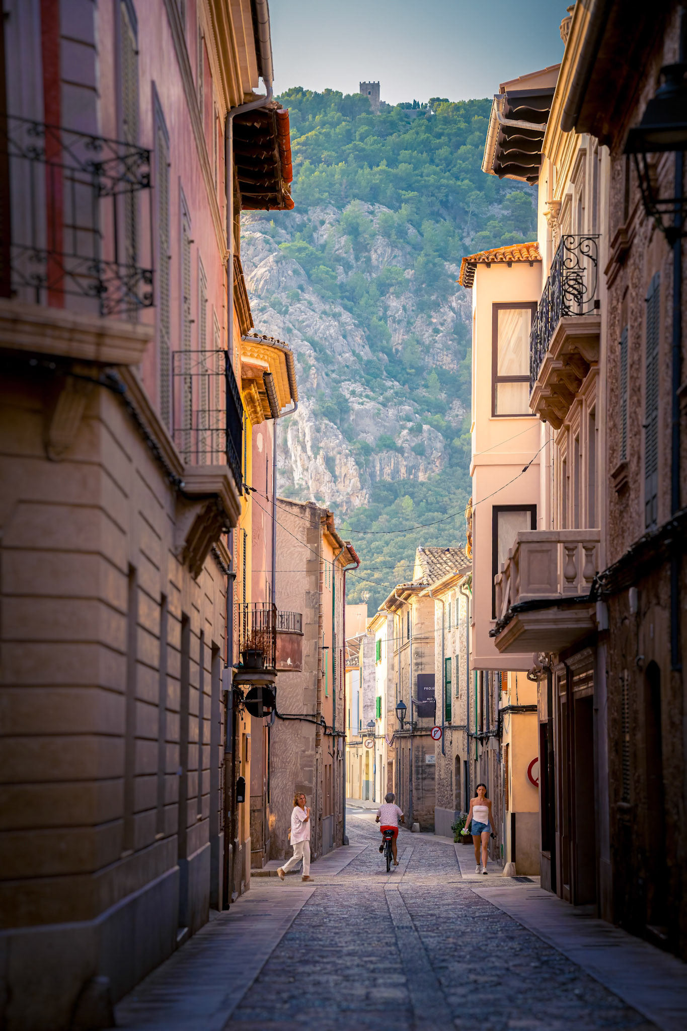 This street scene of Pollensa was taken just as the town was starting to wake up. The low sun creates string shadows and naturally highlights the streets that cross in the other direction. One of a selection of images that were taken, waiting for just the right person to enter the scene.