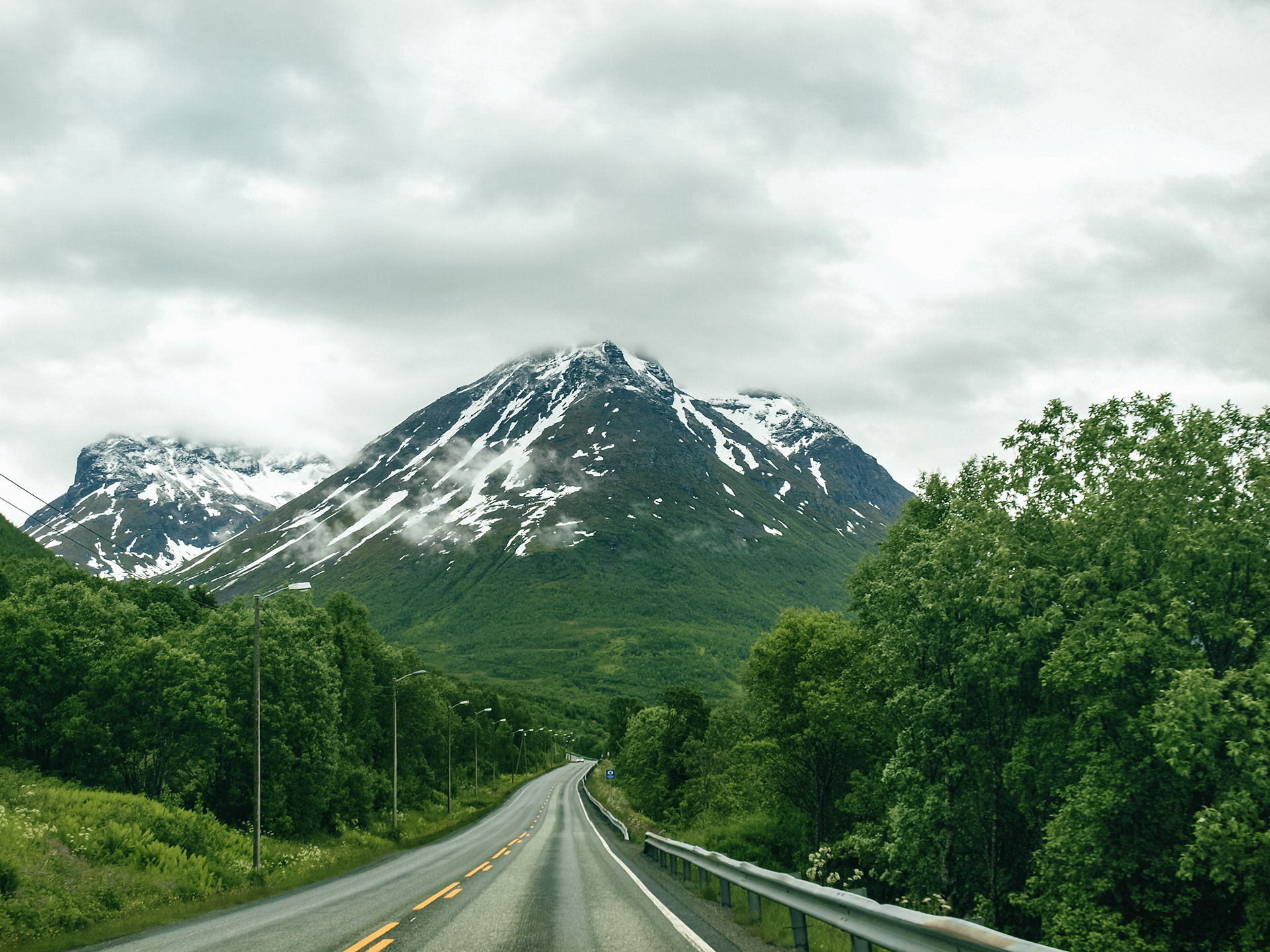 The road to Segla passes by massive peaks shrouded in mist