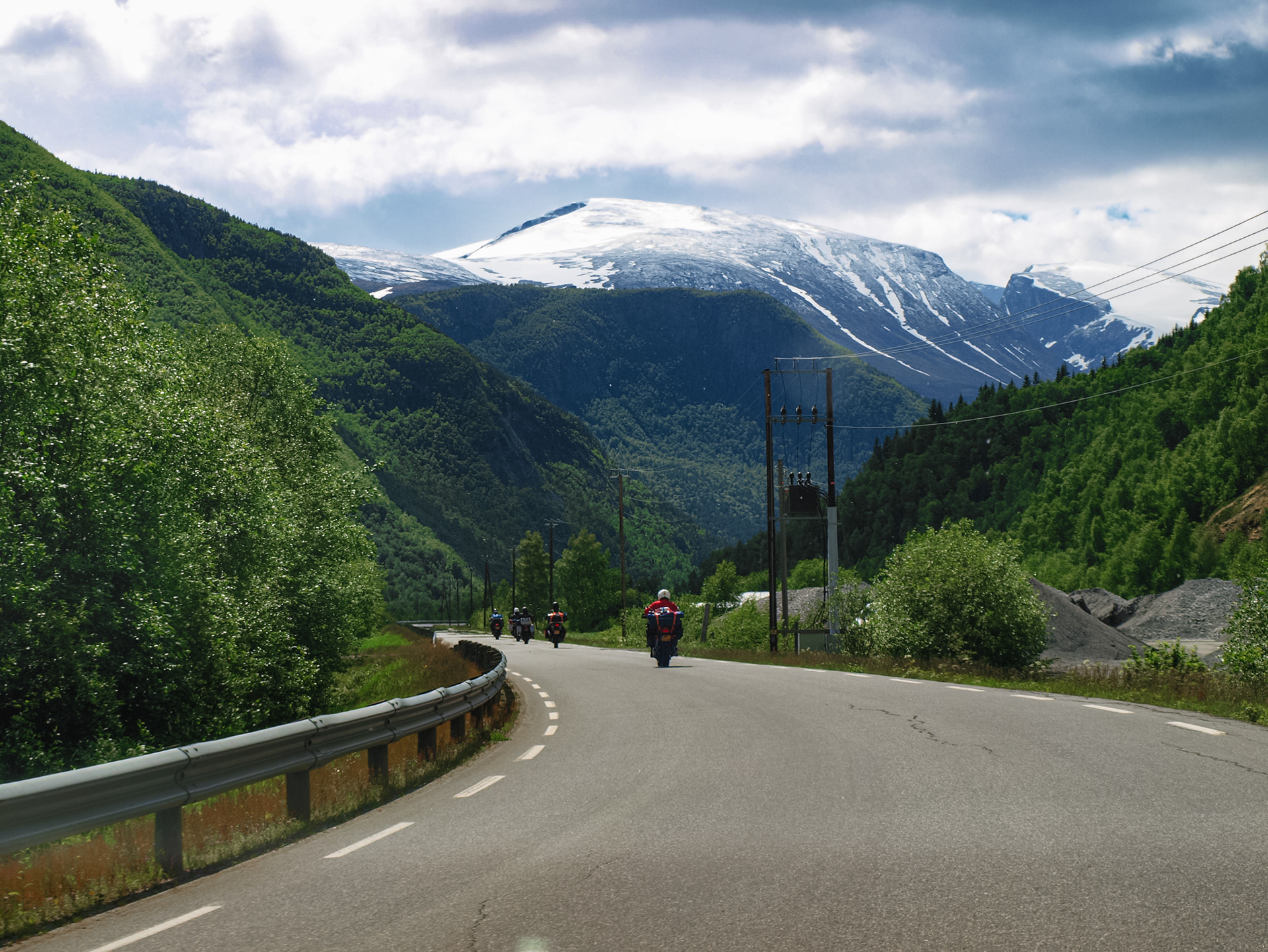 Motorcycles cruising along the road to Spiterstulen