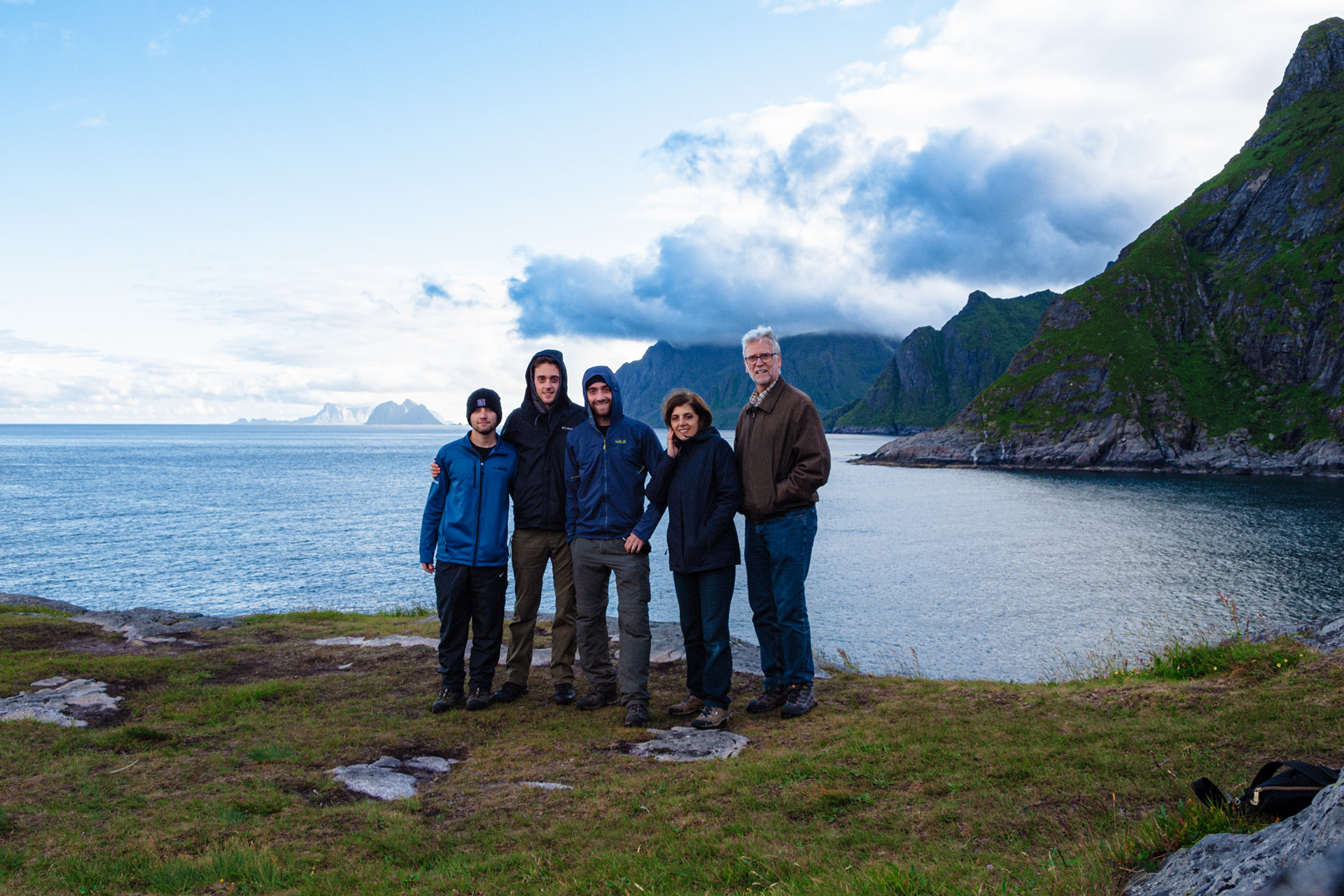 Nick, James, Rob, Paula, and Bob pose near the water in Reine, Lofoten