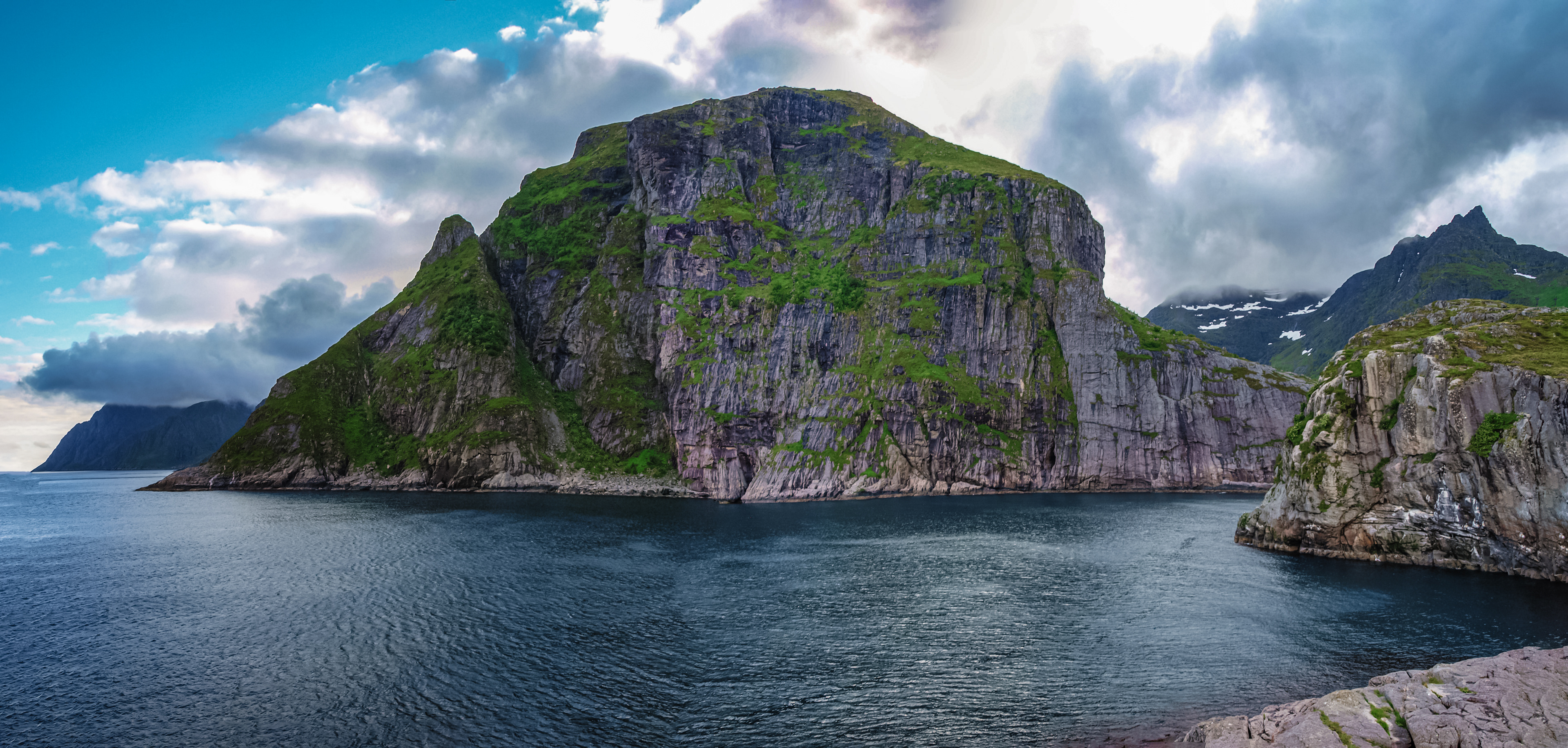 Massive rock formations seemingly jut out of the sea in the Lofoten Islands