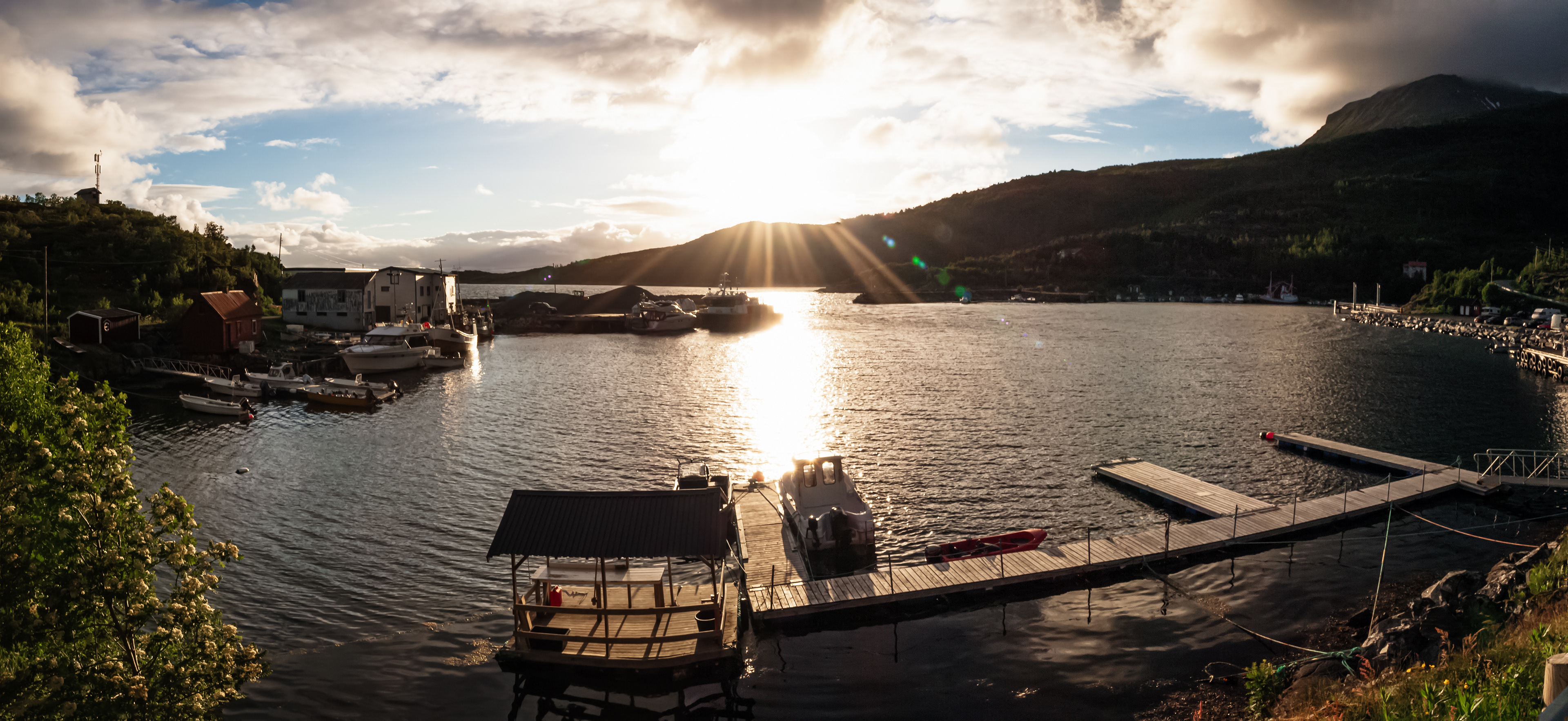 The sun gets low over a small dock in Skrolsvik