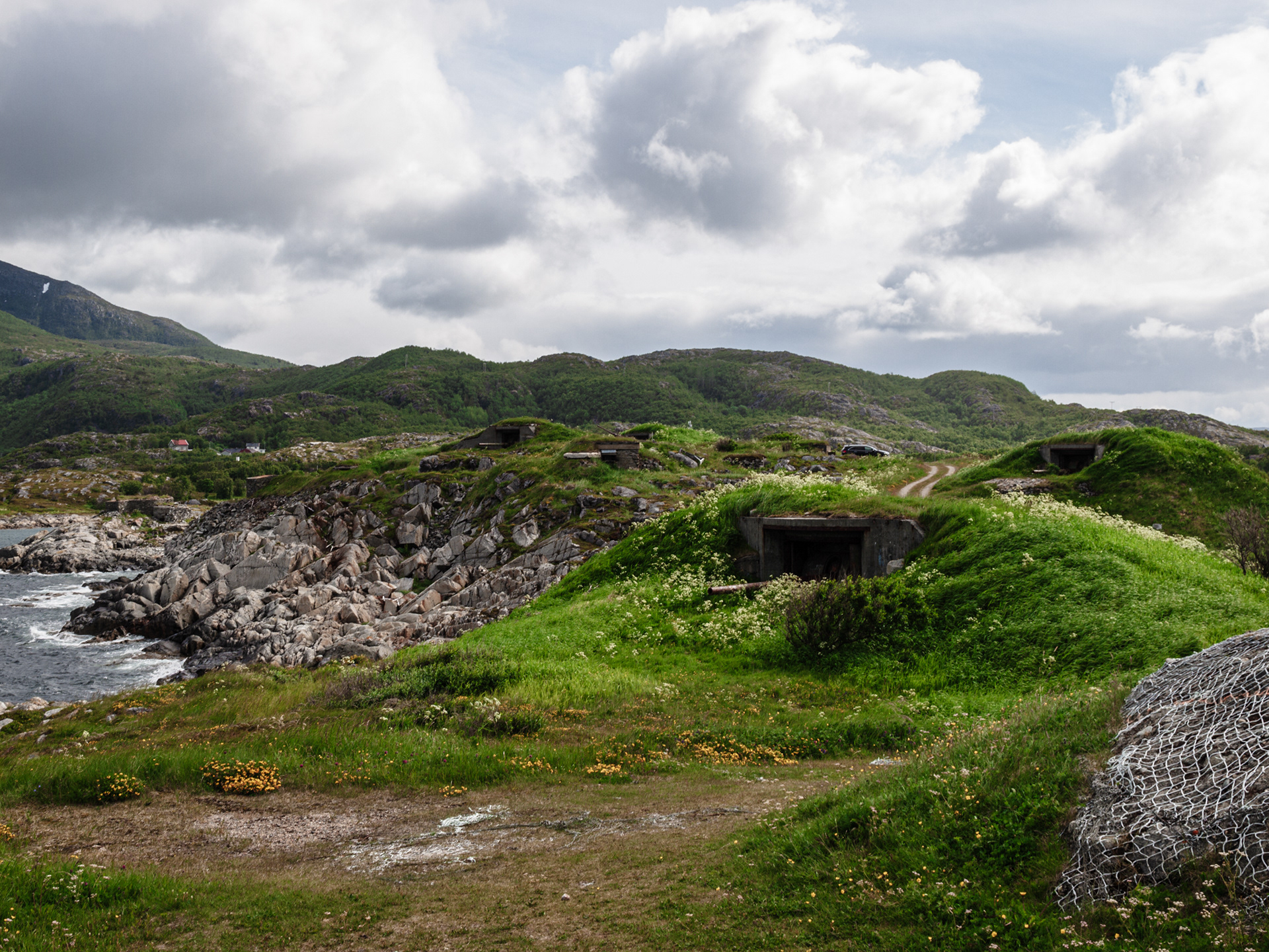 Rusting German artillery protrude from old bunkers that now blend into the landscape in Skrolsvik