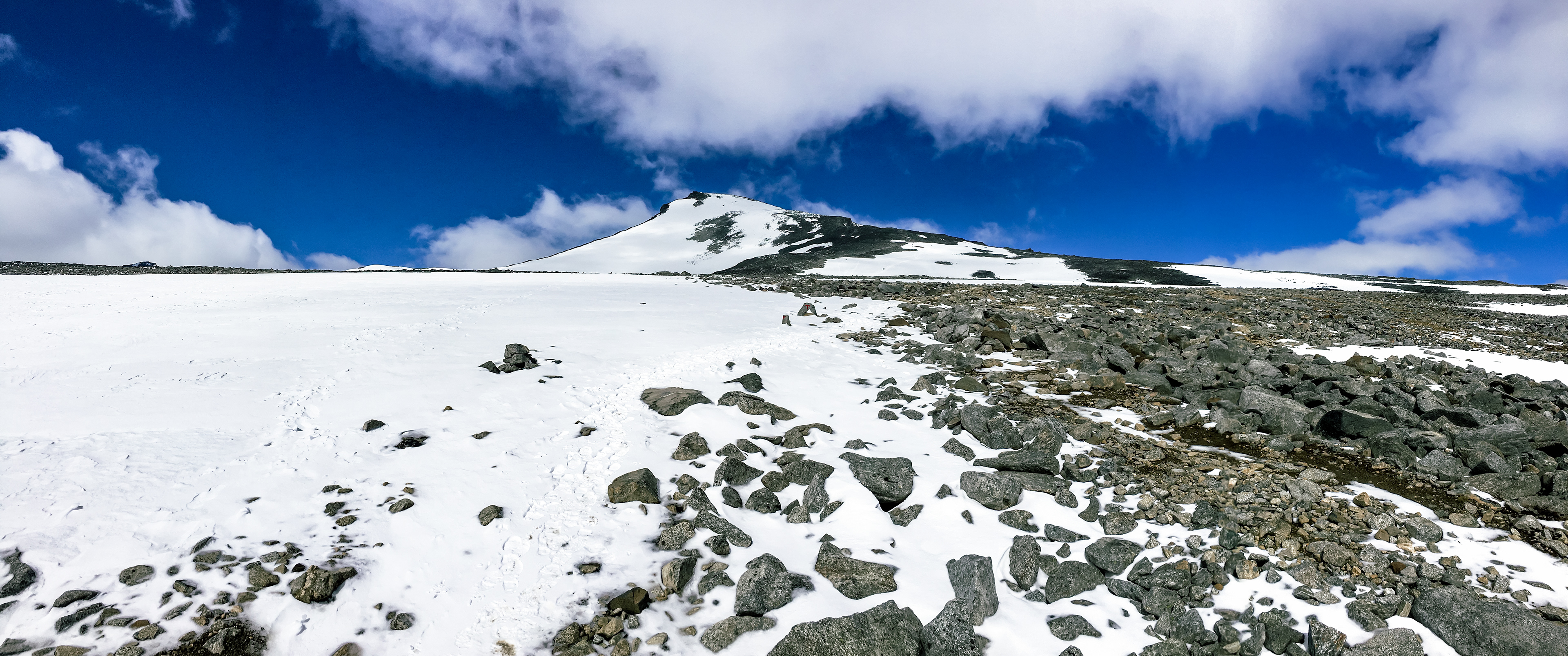 The peak finally comes into view while hiking up Galdhøpiggen