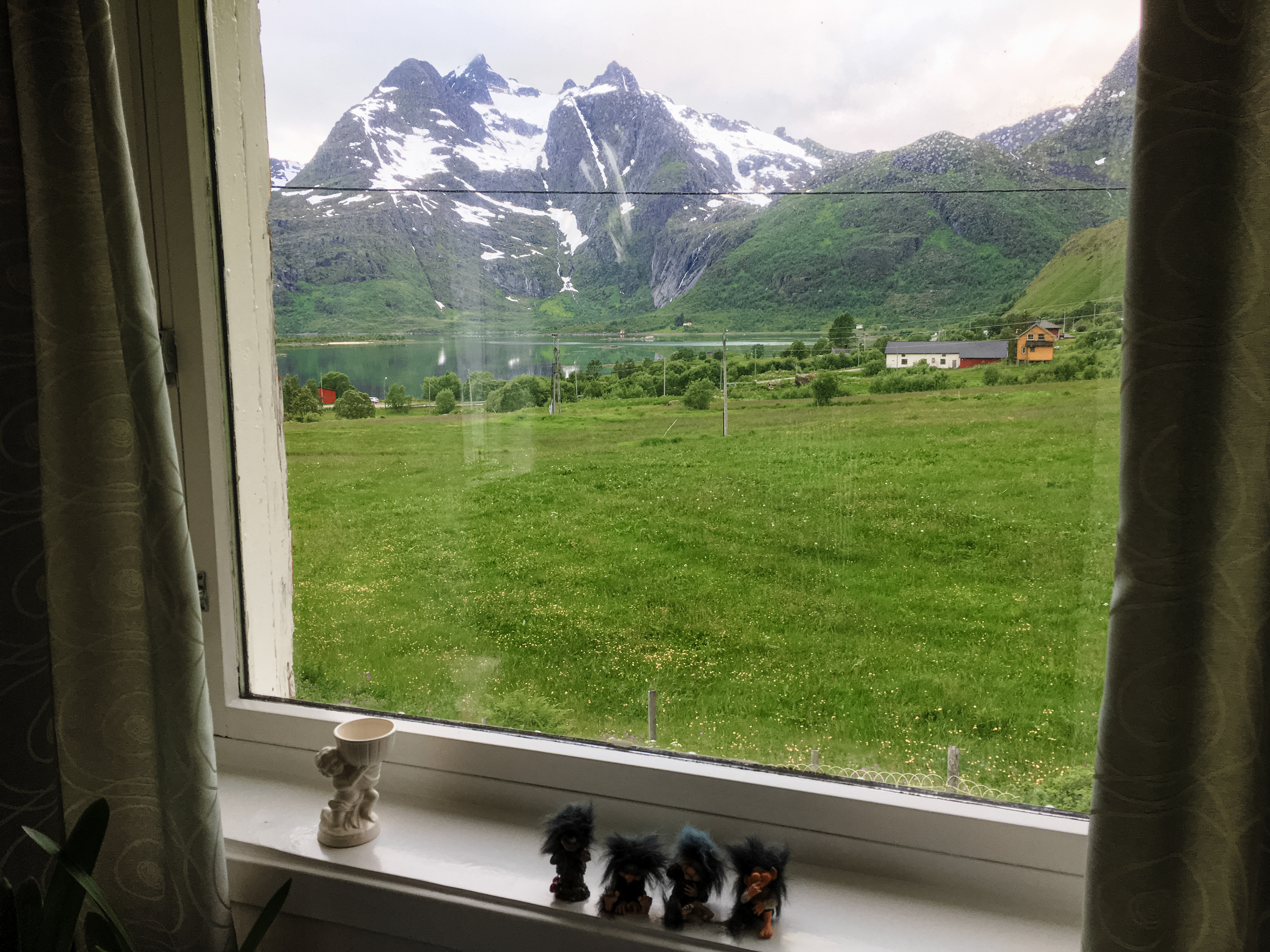 Snowcapped peaks are visible from the window of the farmhouse