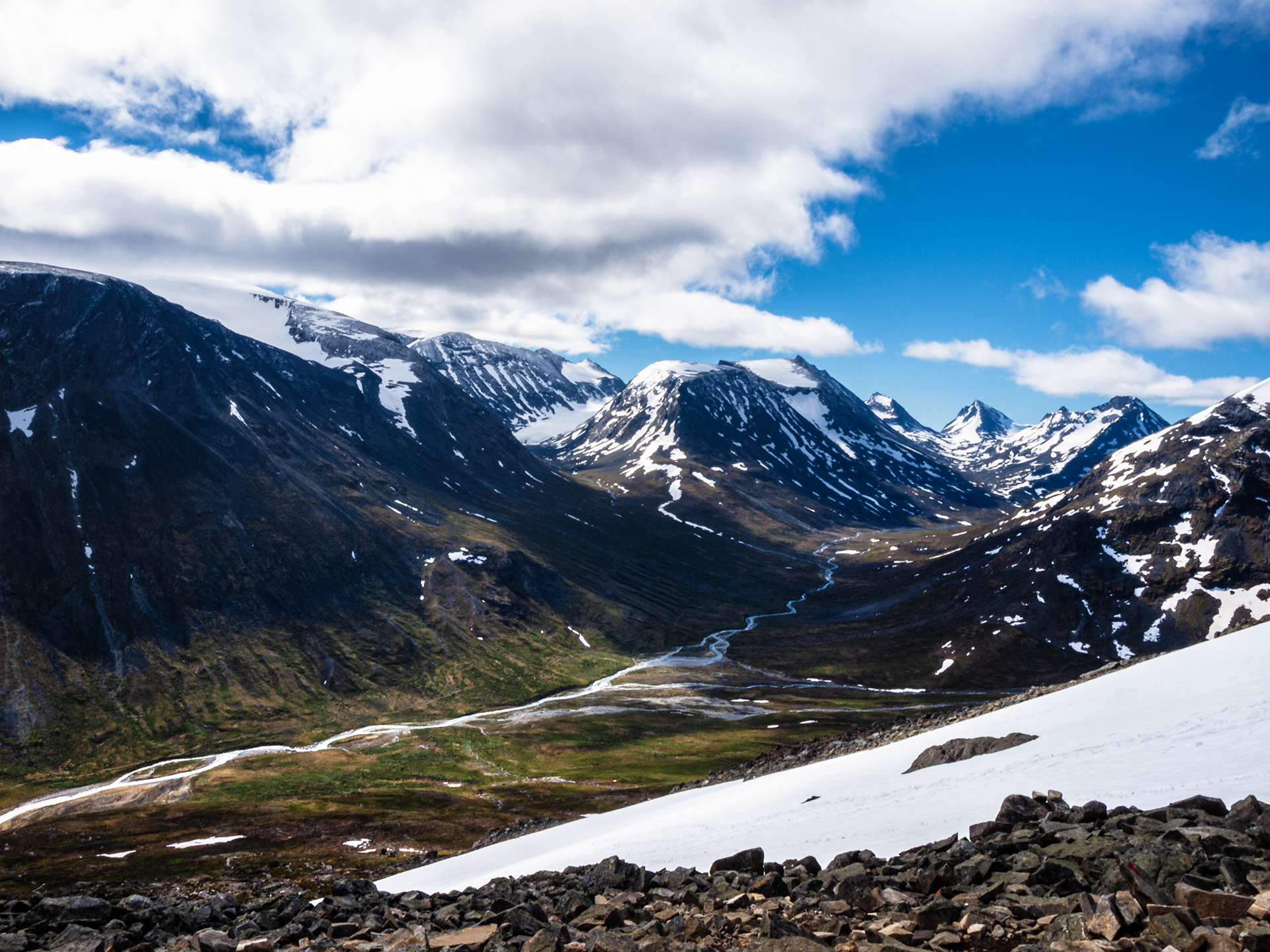 A first glimpse of snow on the trail to the summit of Galdhøpiggen. Other mountains within Jotunheimen Nasjonalpark are visible in the distance.