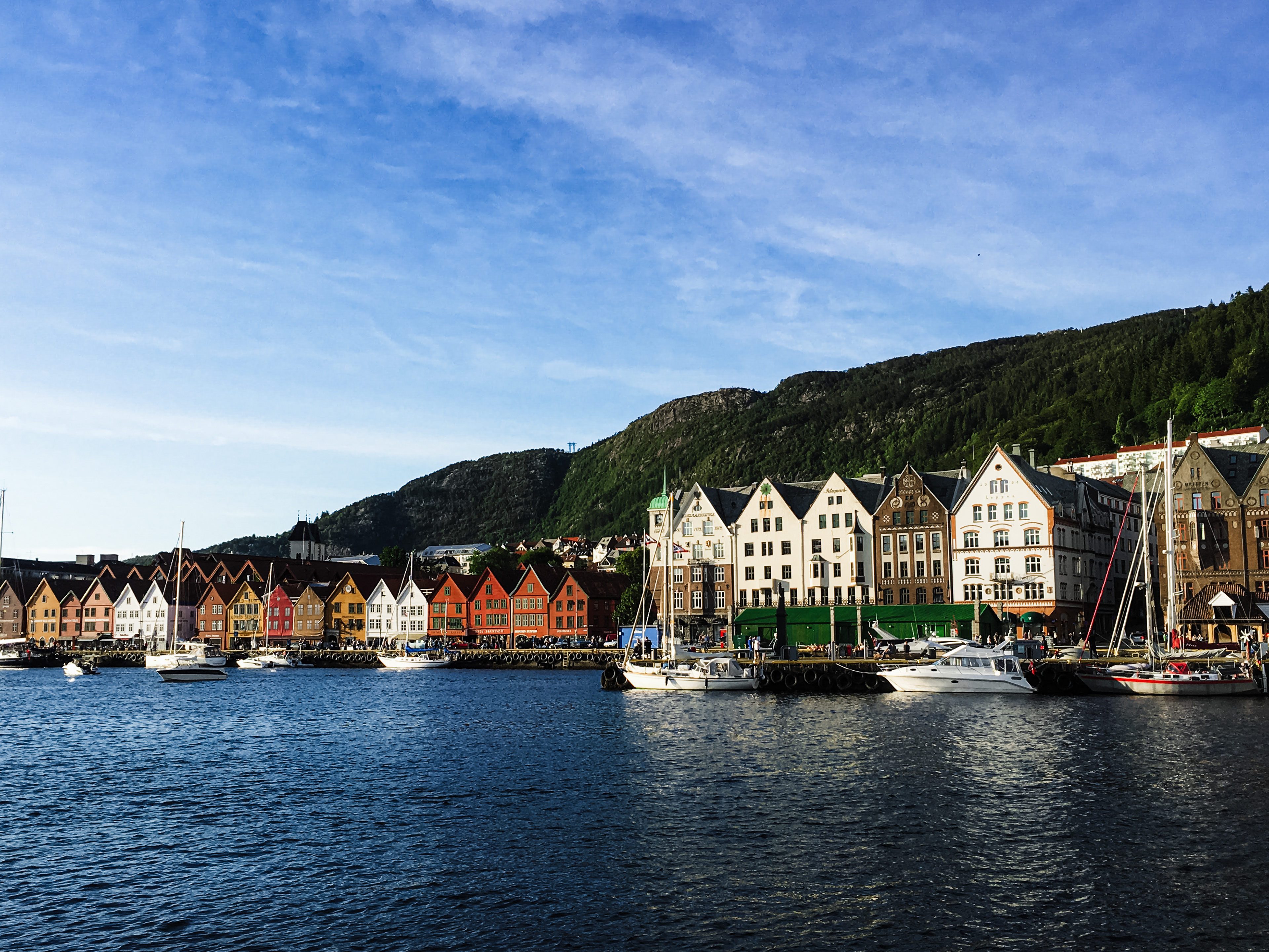 Sailboats docked near the picturesque buildings at the water's edge in Bergen
