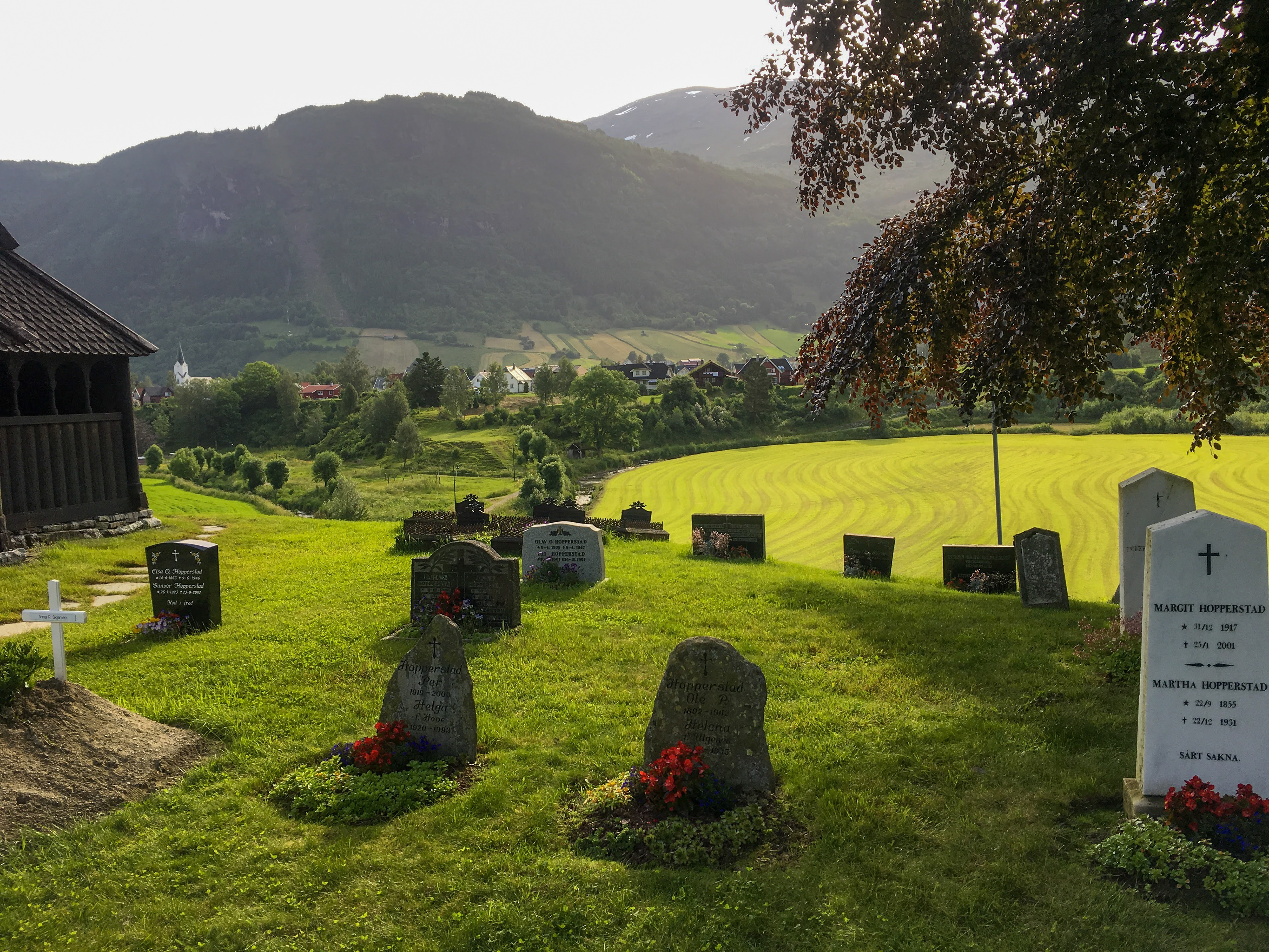 Soft light illuminates a small cemetery at a stave church near Bergen