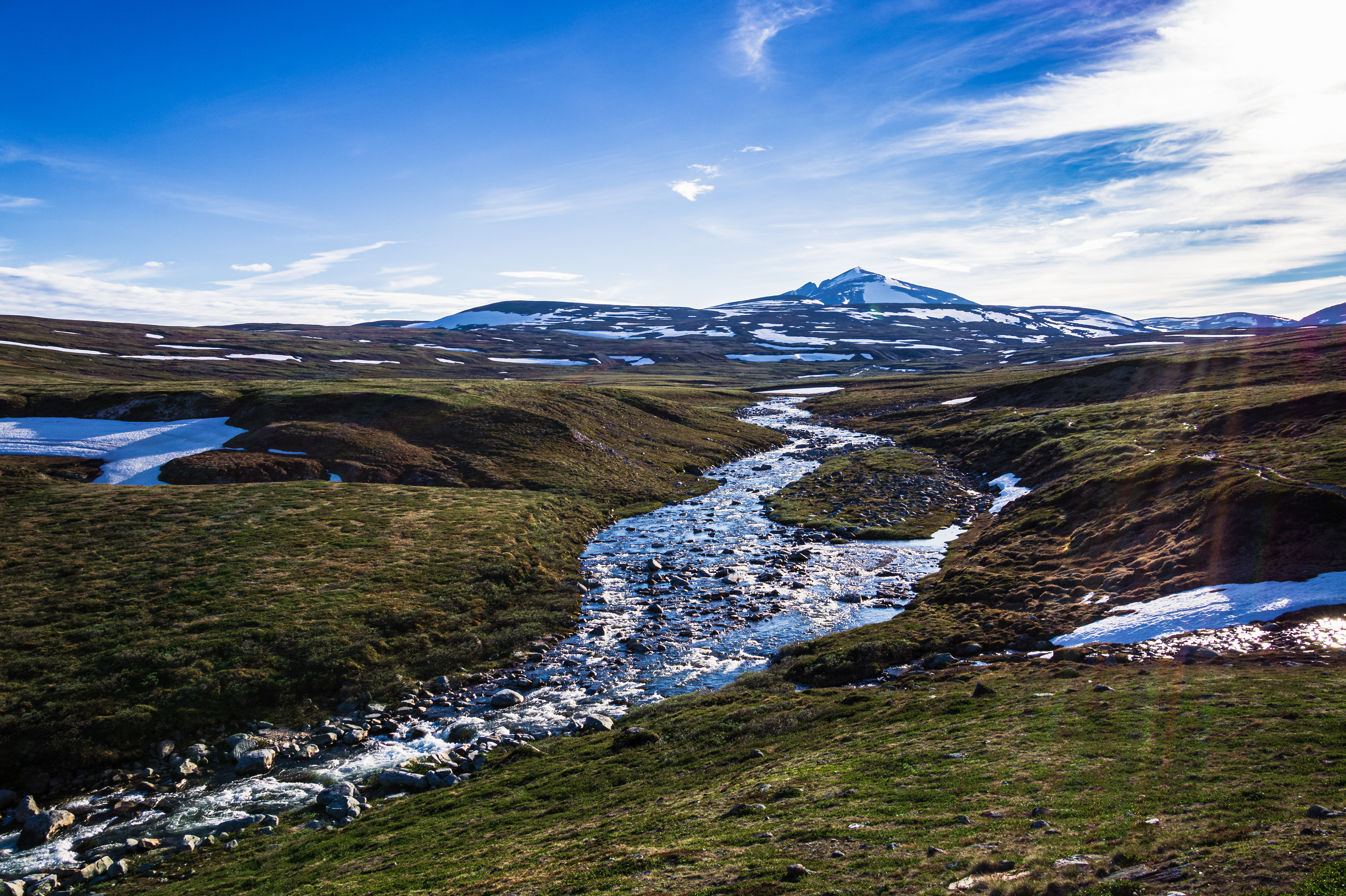 The summer sun melts snow in Dovrefjell-Sunndalsfjella Nasjonalpark, causing mountain streams to grow