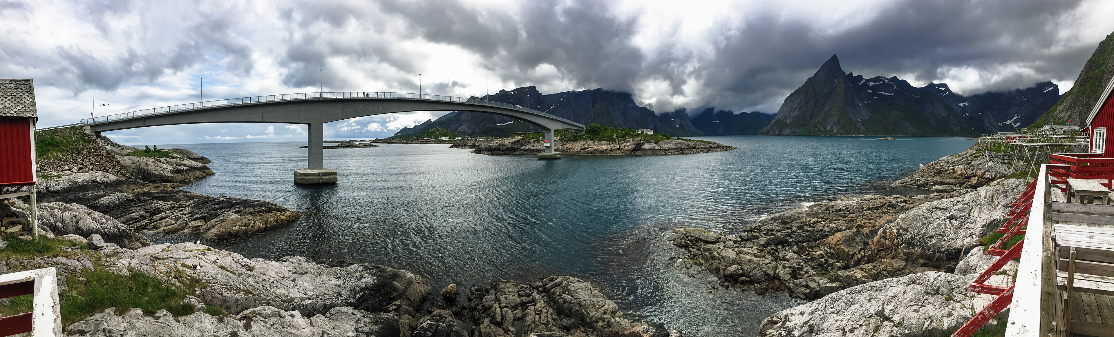 Clouds shroud the peaks of Lofoten's jagged mountains, as seen from the rorbuer