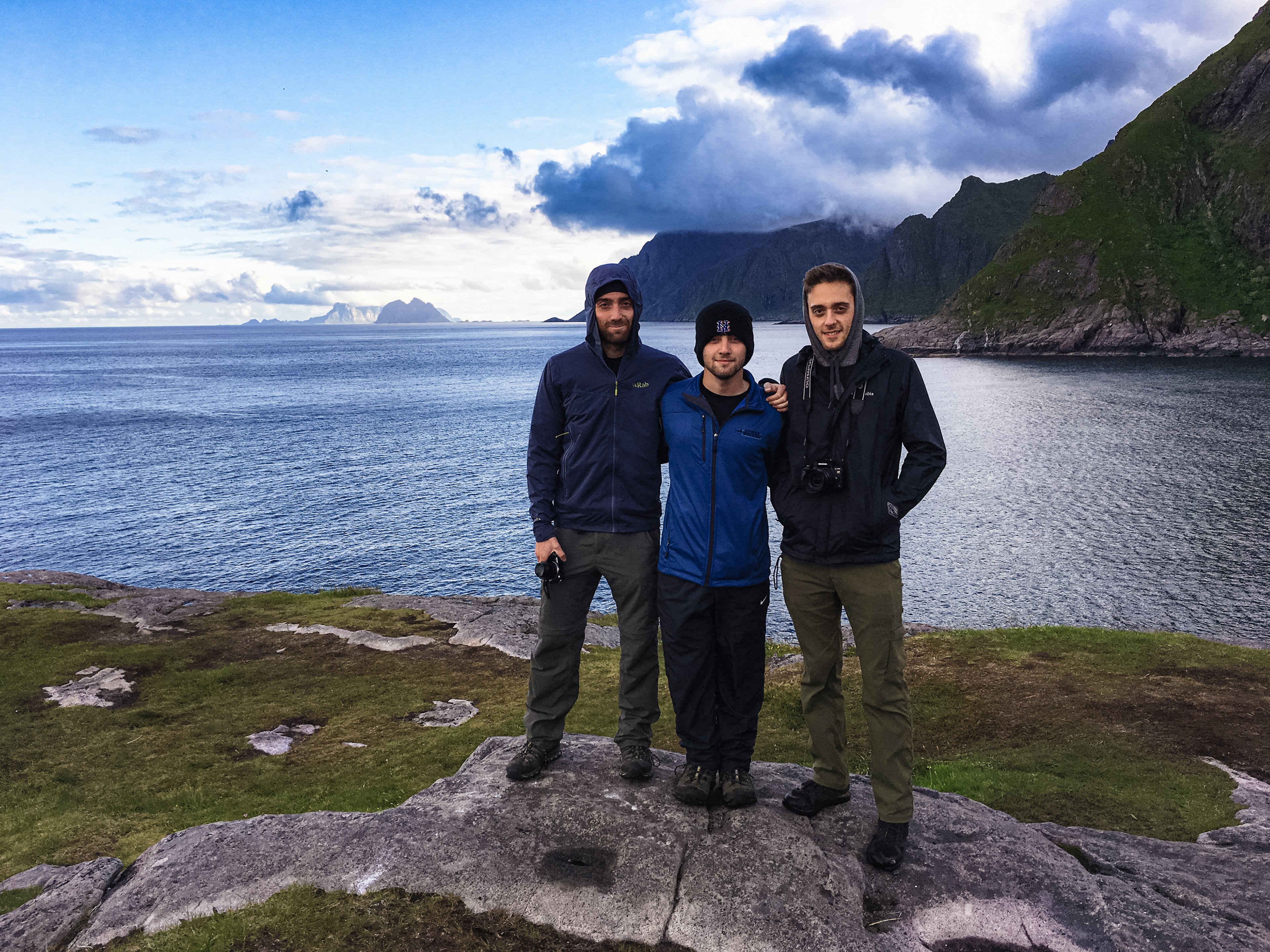 Rob, Nick, and James pose near the water in Reine, Lofoten
