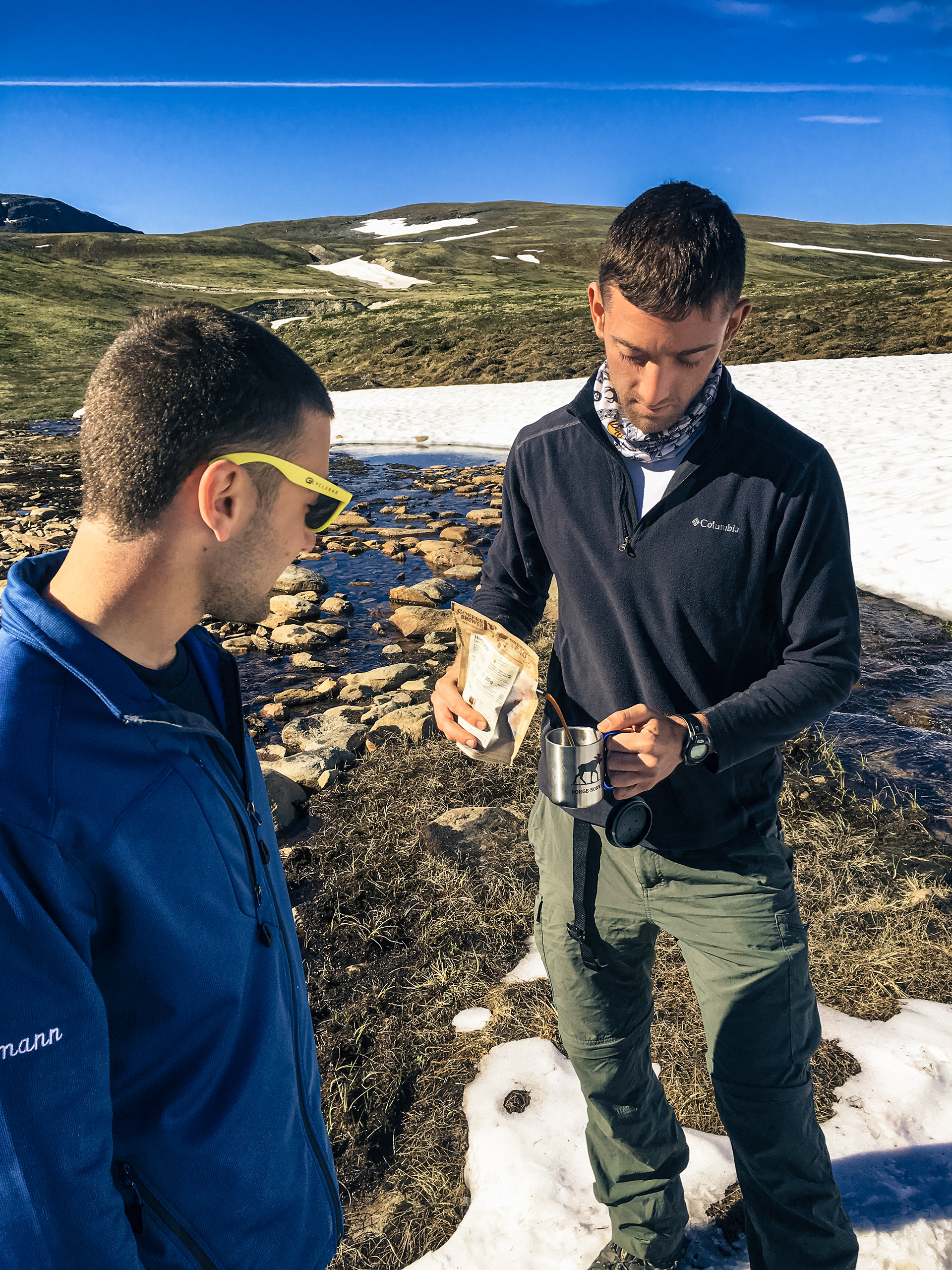 Nick watches as Rob brews some coffee in the morning after camping in Dovrefjell-Sunndalsfjella Nasjonalpark