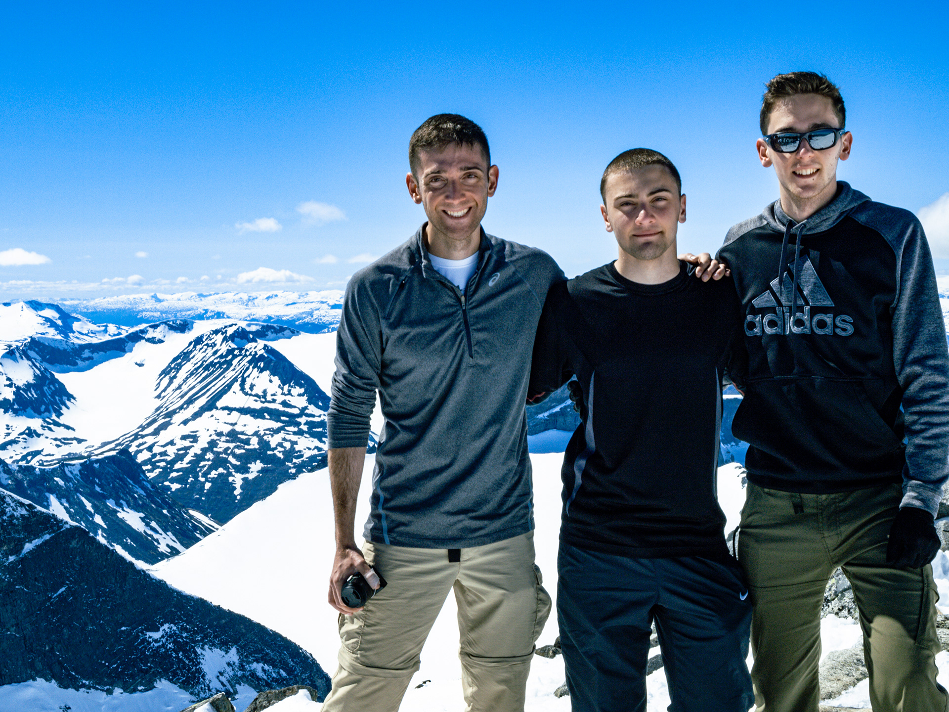 Rob, Nick, and James posing at the summit of Galdhøpiggen ("peak of the steep and rounded mountain")