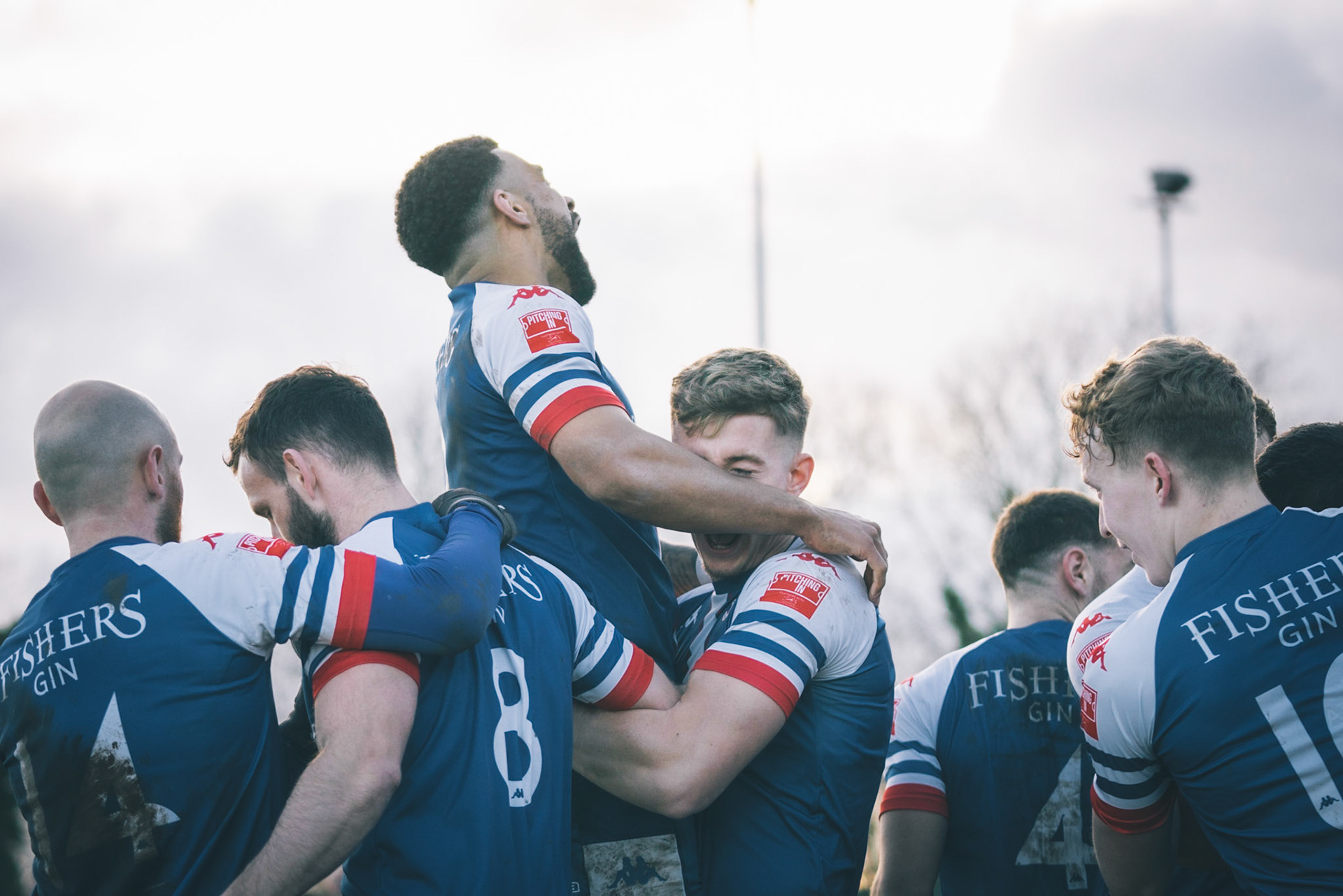 Leiston celebrating with Captain Seb Dunbar leaping on top of goal scorer Will Davies