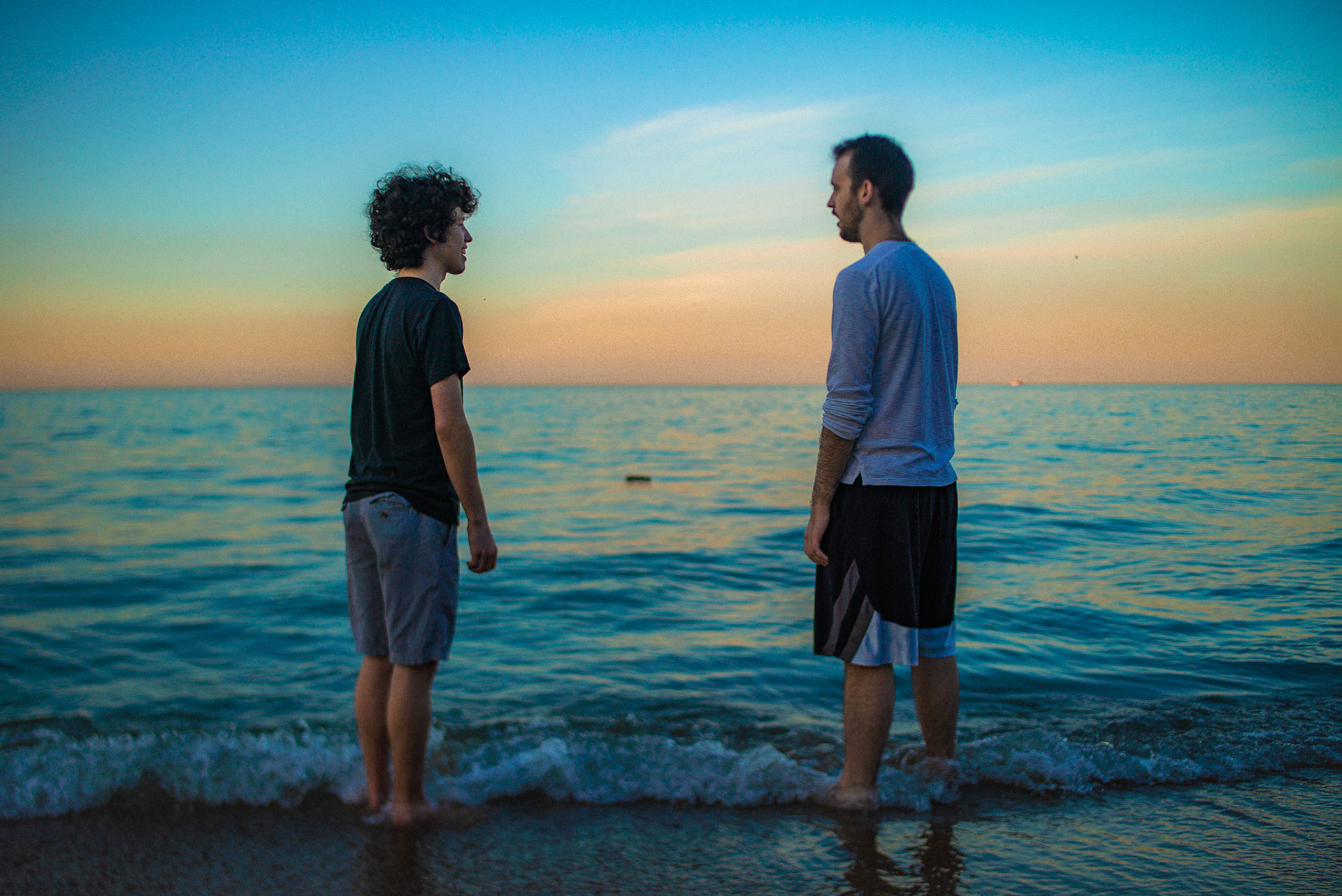 Photo of Josh Leftwich and Nick Klobusicky on Oak Street Beach in Chicago at sunset by Sam Casey