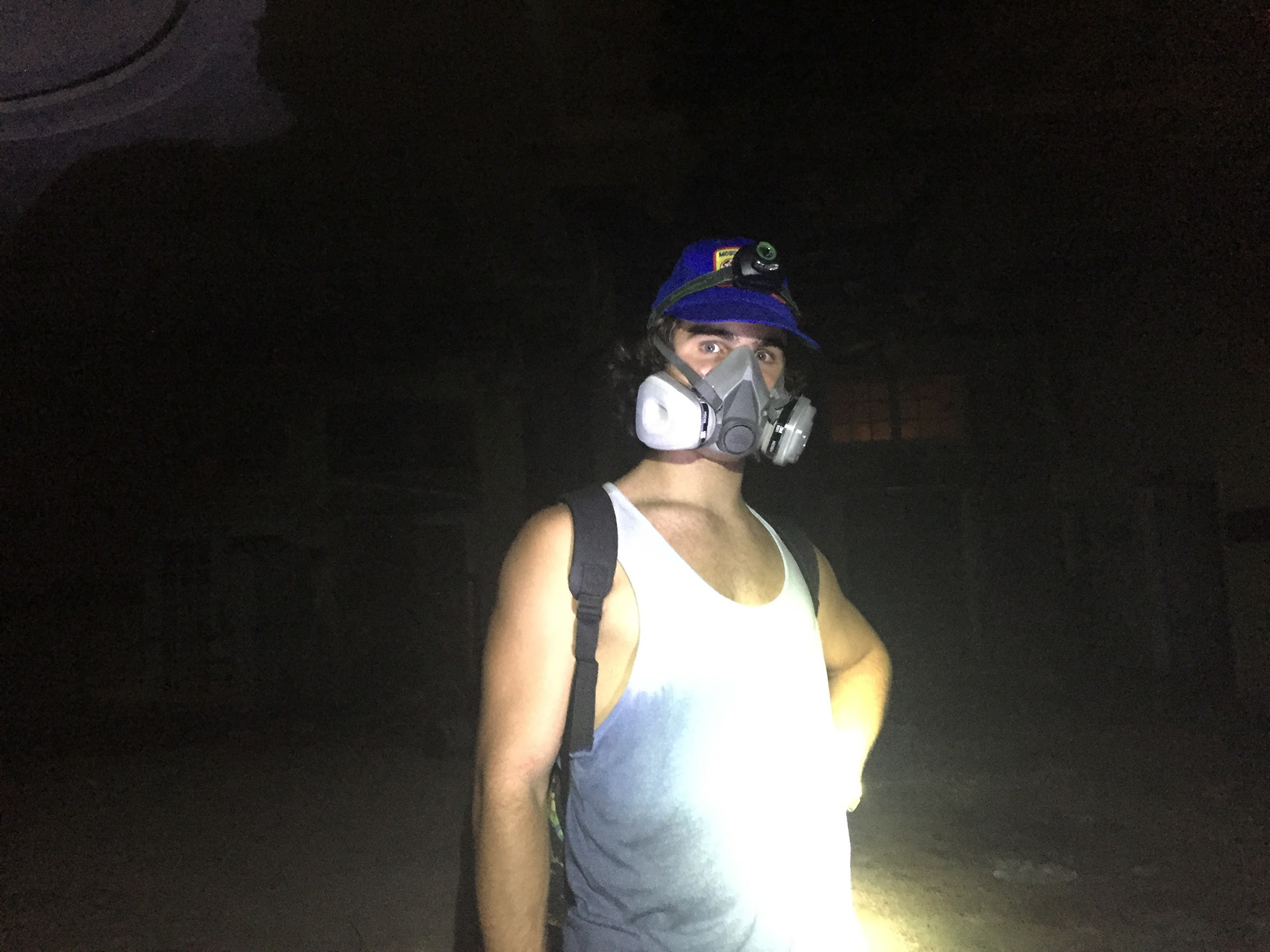 Sam Casey lit by flashlight in The Baker Hotel at night before the renovation process, 2016