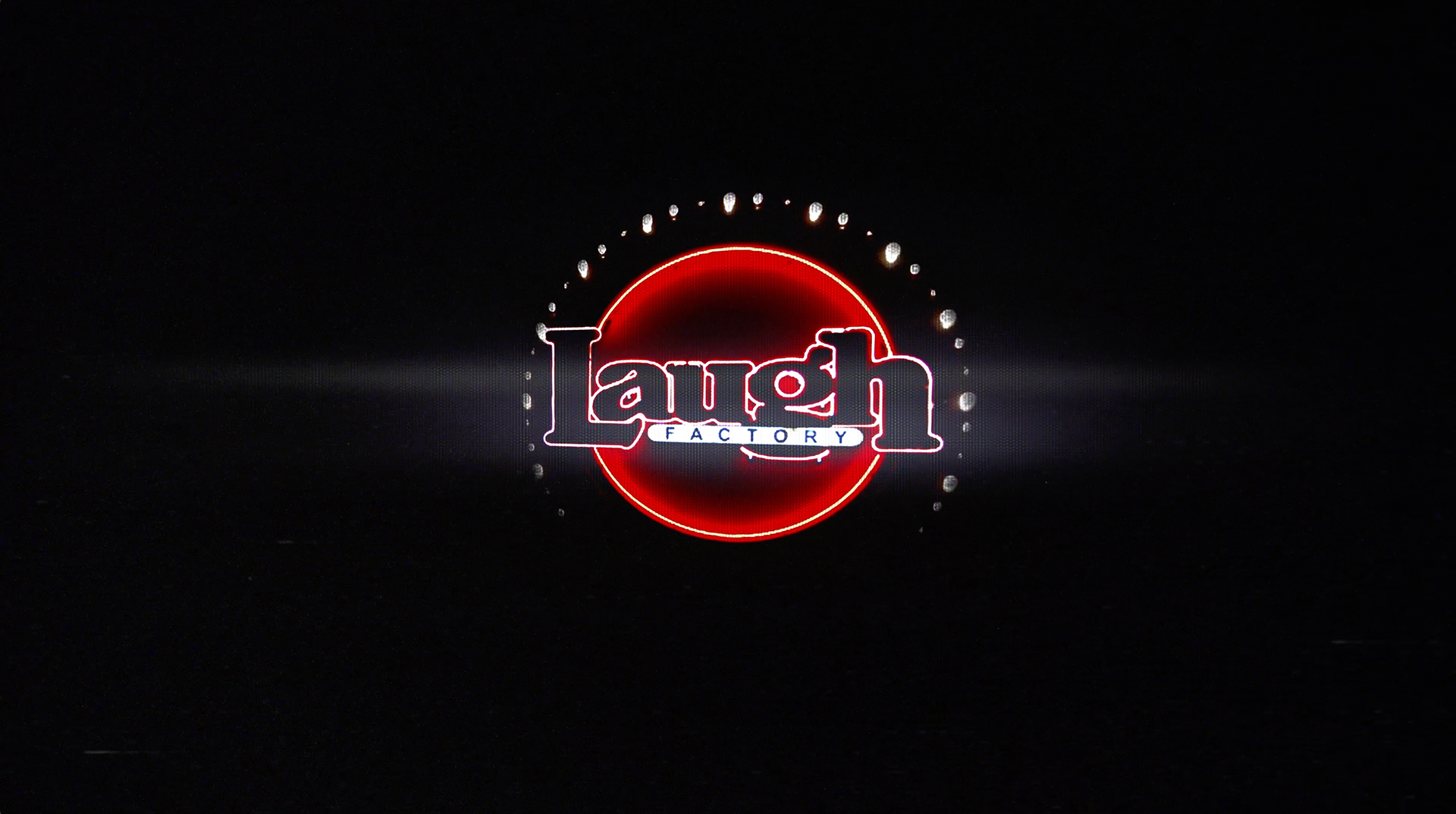Animated Graphic of the Laugh Factory logo neon sign with lens reflections on a black background with alternating lights from the "Laughing Since '79" commercial advertisement, preshow presentation, and parody of the AMC Theaters Nicole Kidman "We Make Movies Better" Advertisement by Carpe Noctem Films, shot by Sam Casey