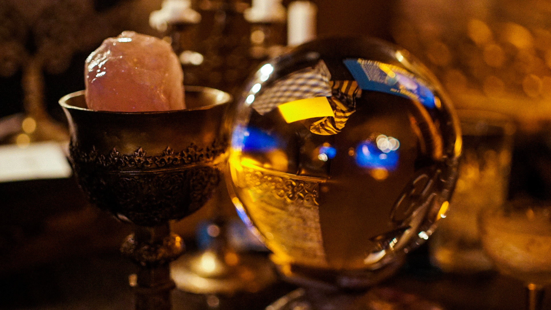 Photo of a healing crystal in a chalice and a palm reader's crystal ball for a commercial advertisement for King of Cups Chicago in warm lighting by Carpe Noctem Films, shot by Sam Casey