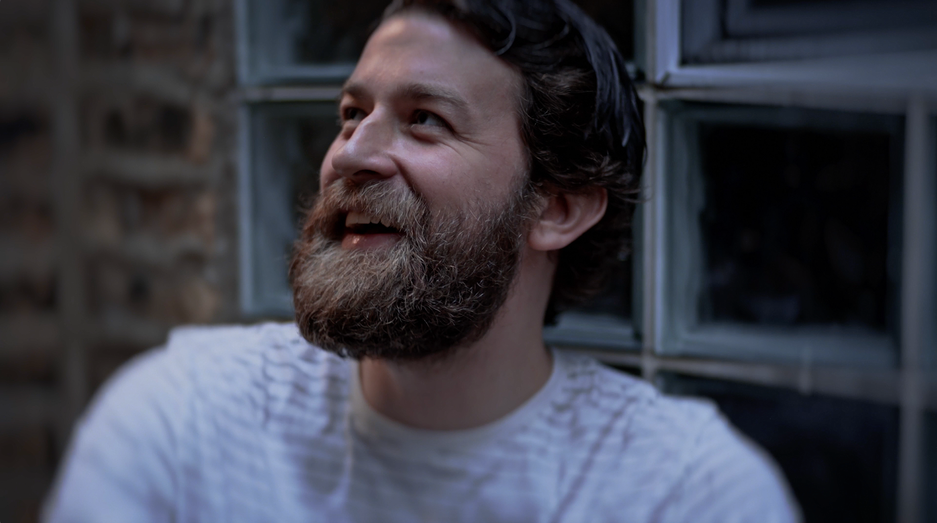 Still of Greg Kennedy laughing on the alley way set in the "Laughing Since '79" commercial advertisement, preshow presentation, and parody of the AMC Theaters Nicole Kidman "We Make Movies Better" advertisement for The Laugh Factory by Carpe Noctem Films