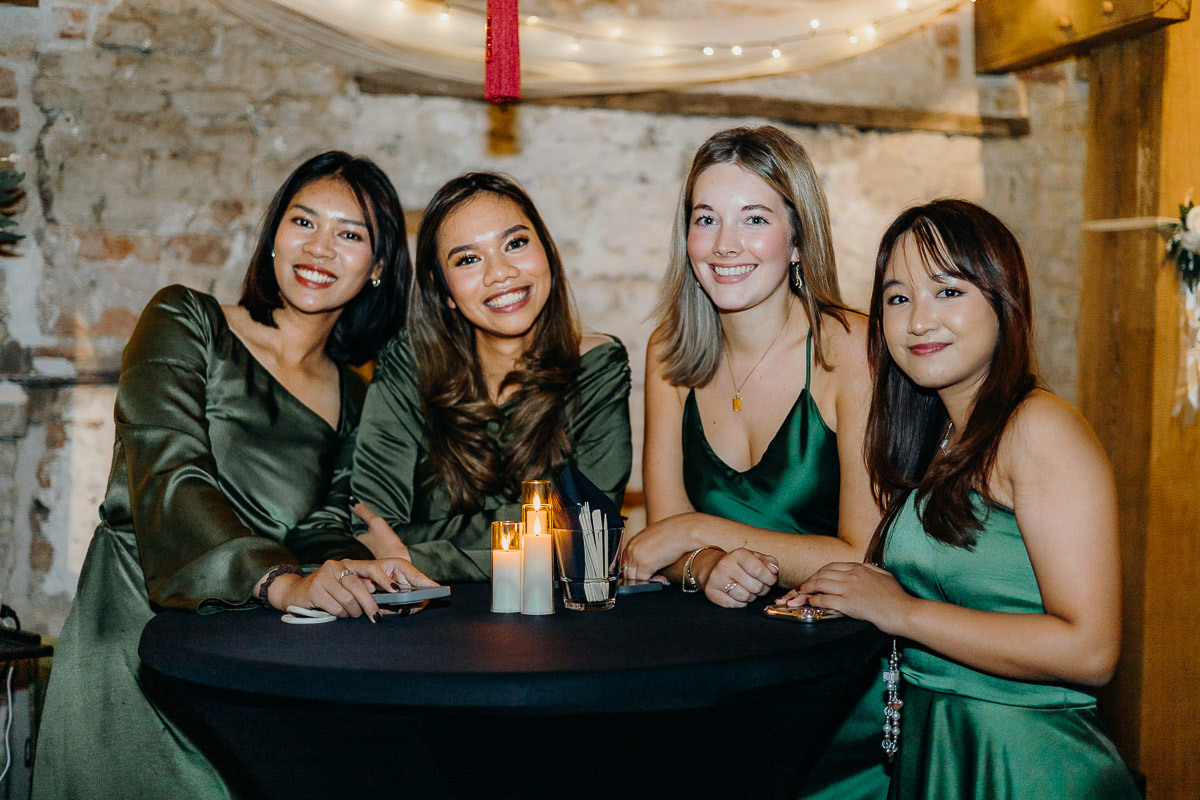 Bridesmaids crew in green dresses.