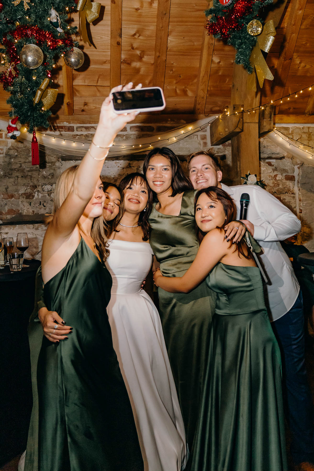 The bridesmaids taking selfie with the bride and a groomsman, photographed by Amsterdam wedding photographer.