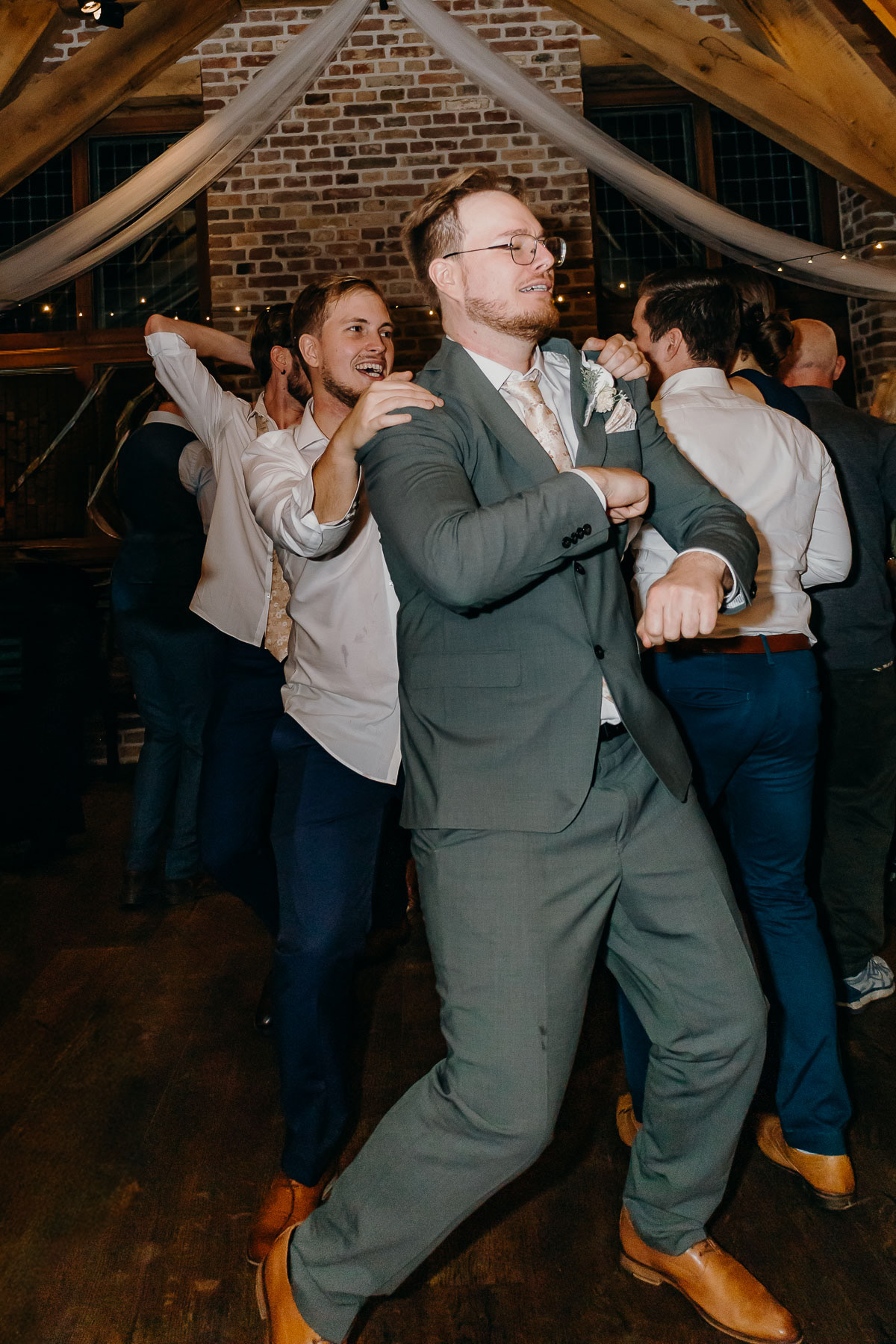 Groom having fun with his brothers and guests at his wedding.