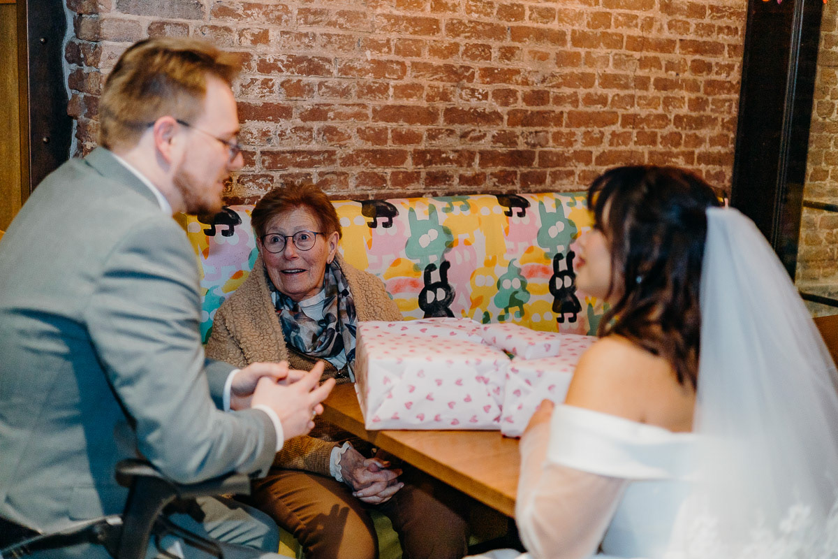 Rotterdam bride and groom opening present from grandma.