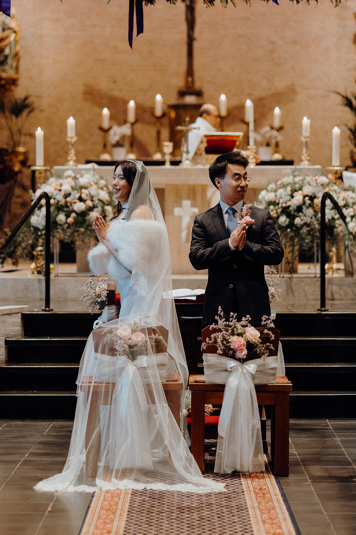 Bride and groom gesturing thank you to their guests, photographed by Amsterdam wedding photographer.