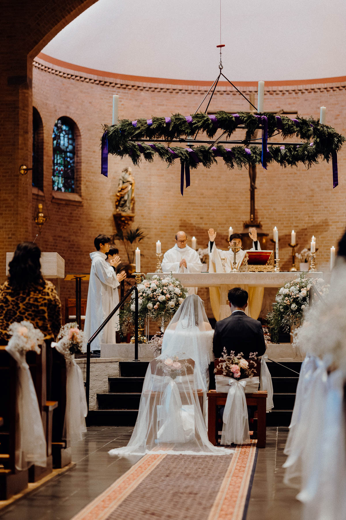 Bride and groom being blessed by the church pastor in their wedding, photographed by wedding photographer Rotterdam.