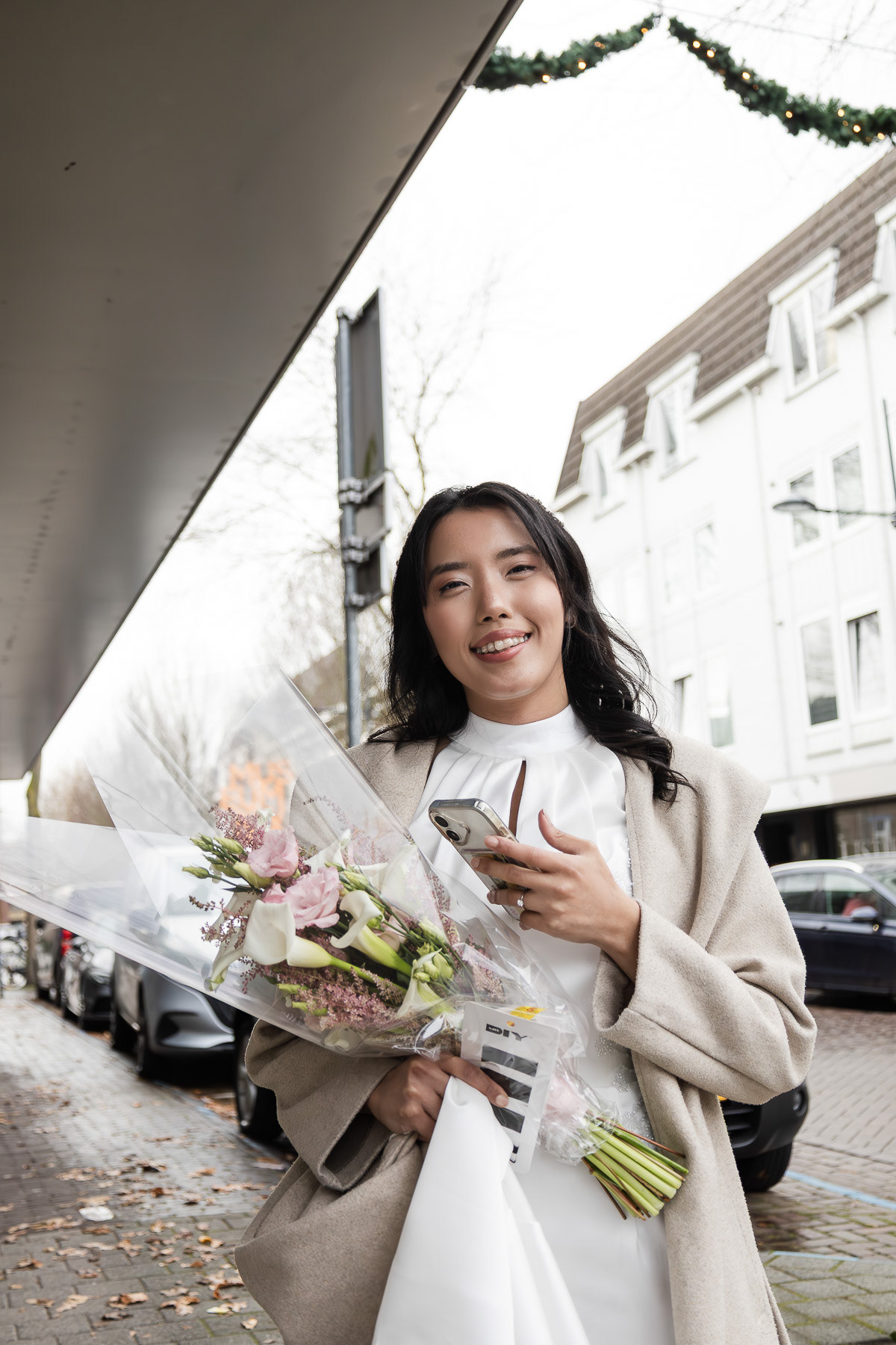 The bride waiting for her car to go to the wedding venue.