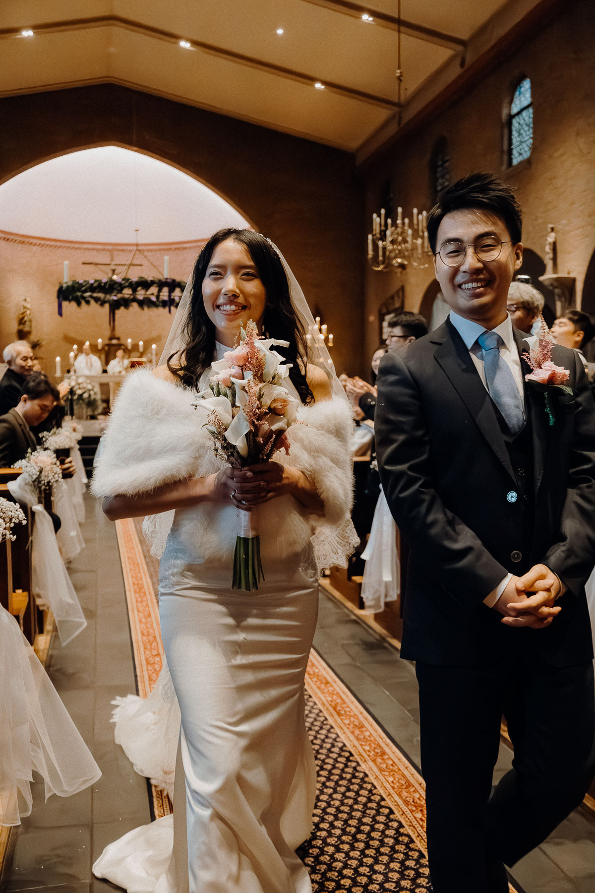 Newly weds walking out of the wedding venue, shot by Amsterdam wedding photographer.
