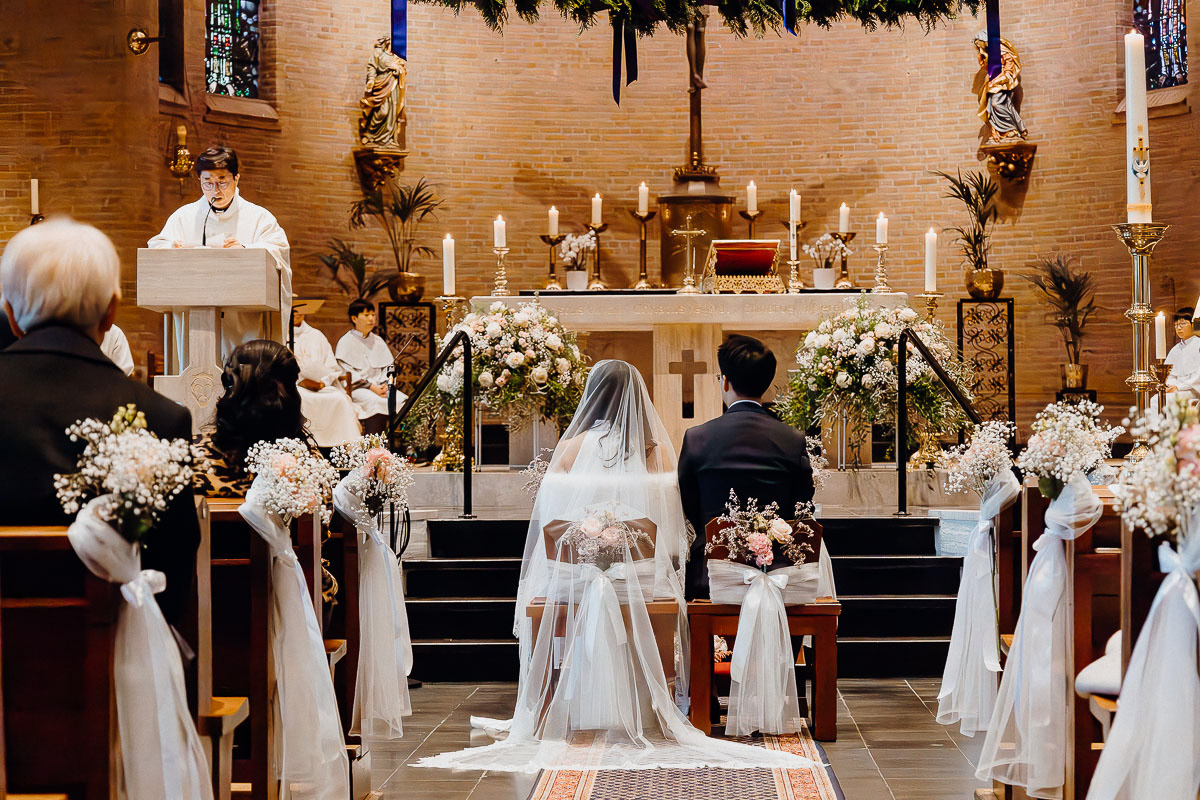 Bride and groom attentively listening to the ceremony.