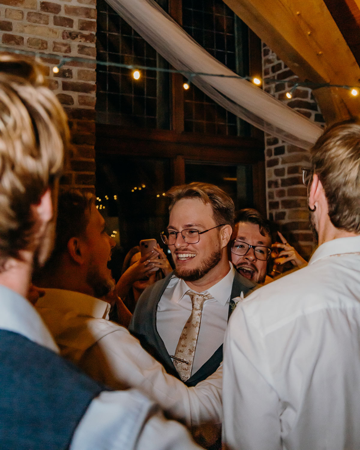 The groom having fun with the groomsmen, photographed by Amsterdam wedding photographer.