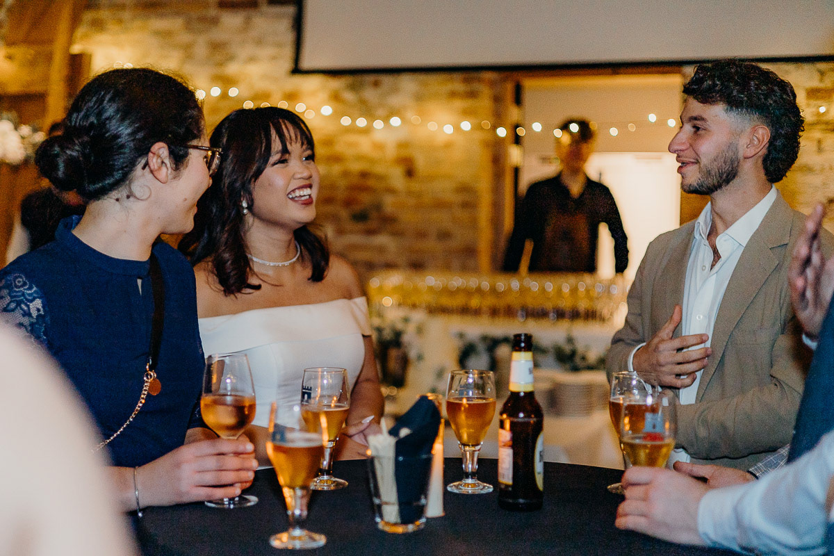 Bride interacting with guests at the table.