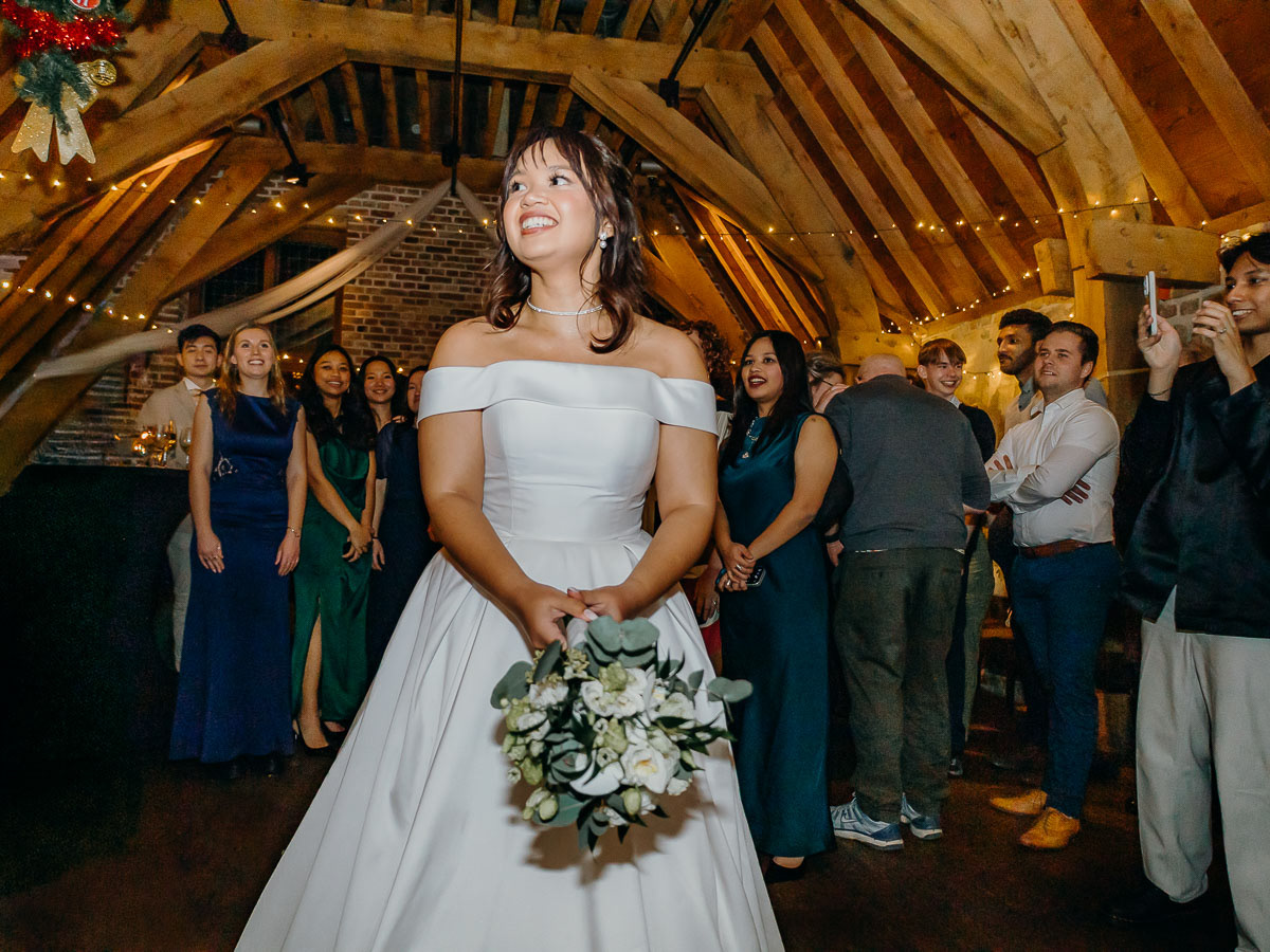Bride throwing her flower bouquet to the guests.