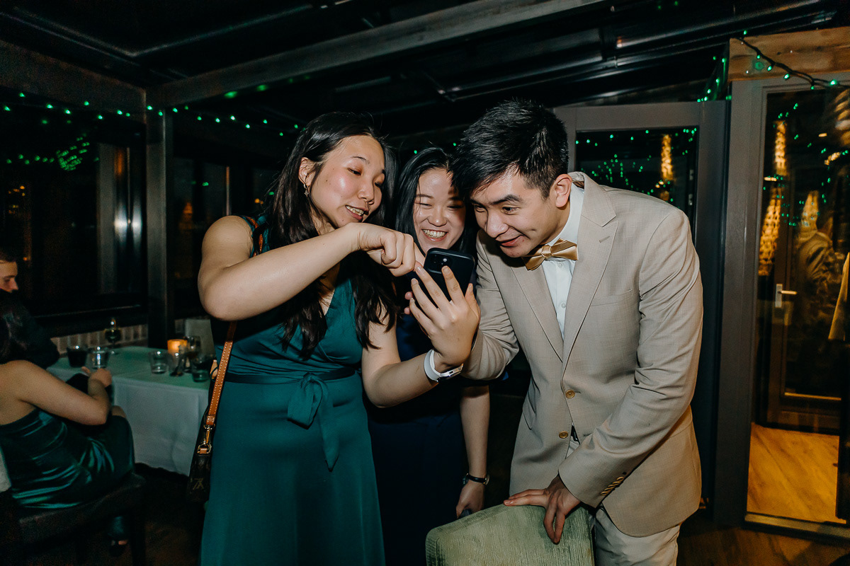 Three friends having fun over a phone.