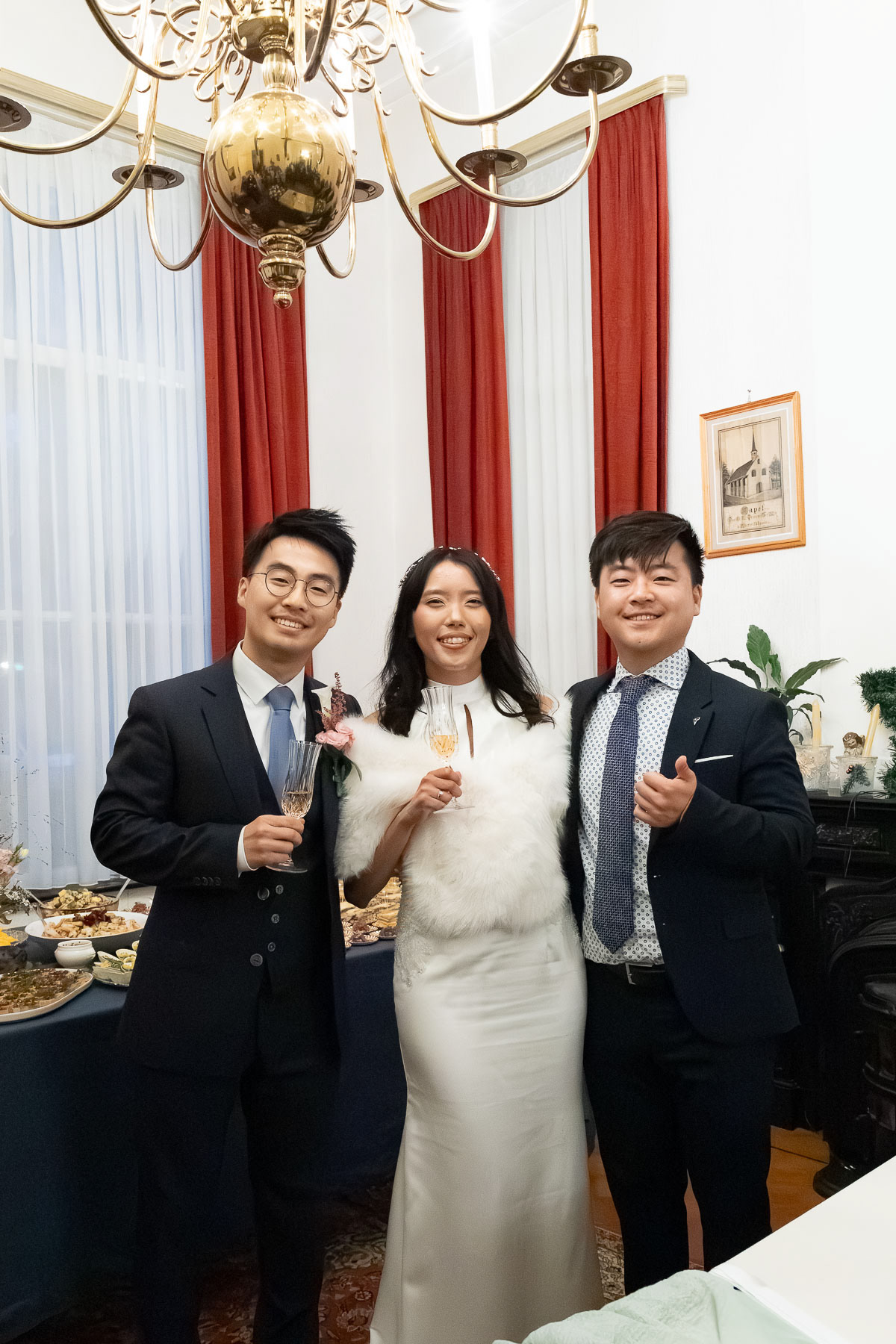 Photo of the bride, groom, and the groom's brother after the wedding, taken by Amsterdam wedding photographer.