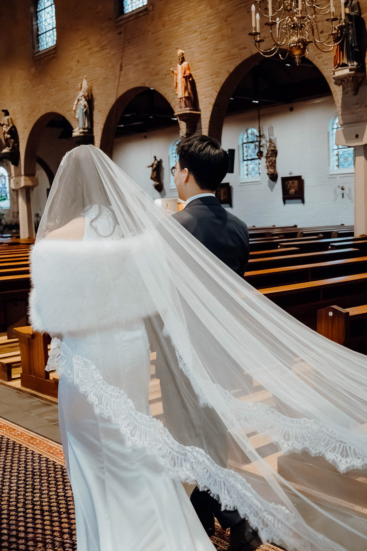Bride and groom entering the church, taken by Amsterdam wedding photographer.