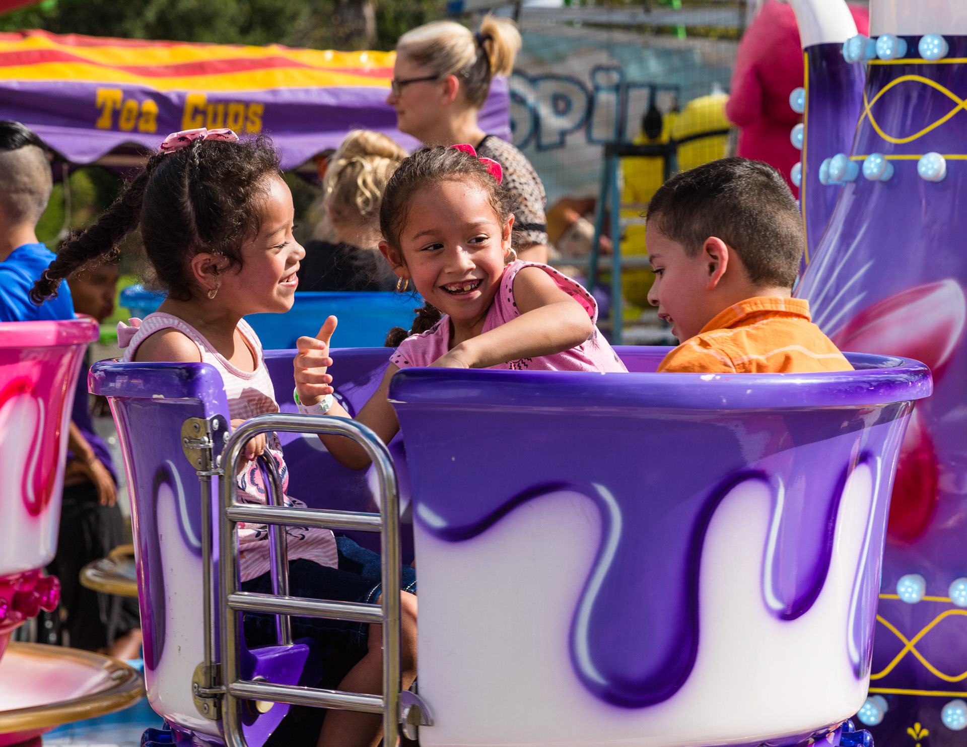 Siblings Nathalie, Luisa and Jacob Juarez, with smiles from ear-to-ear, spin as fast as they can on a teacup ride at the VFW Carnival Saturday afternoon, October 6, 2018, in Lufkin, Texas. (Cara Campbell/The Lufkin Daily News)