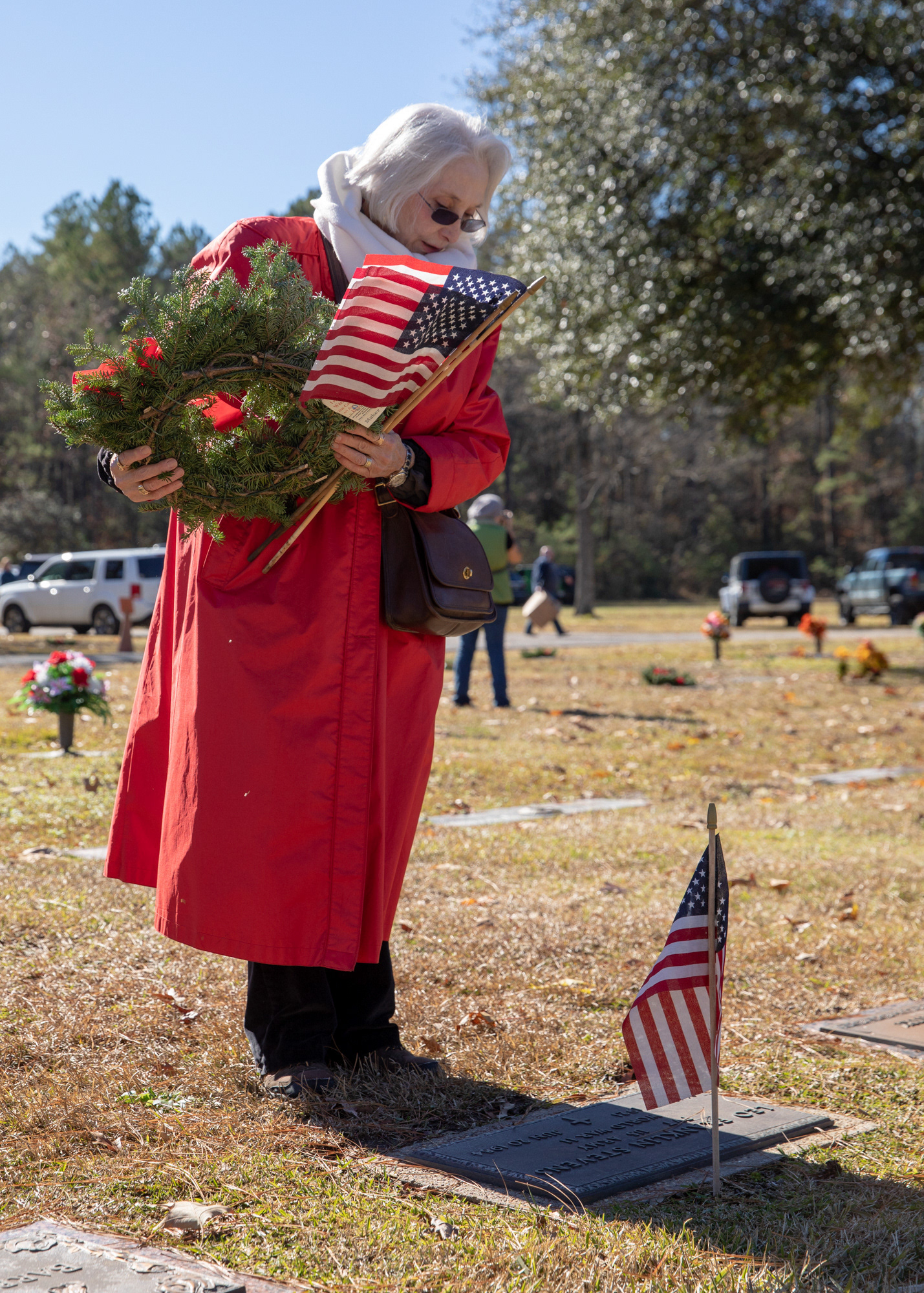 Jane Brown pauses for a moment of silence in front of fallen World War II Army veteran Leo Franklin Stevens grave site before placing a wreath on his head stone during Wreaths Across America Saturday morning, December 15, 2018, at Garden of Memories Memorial Park in Lufkin, Texas. Brown said she attended the event “Because I love my country.” (Cara Campbell/The Lufkin Daily News)