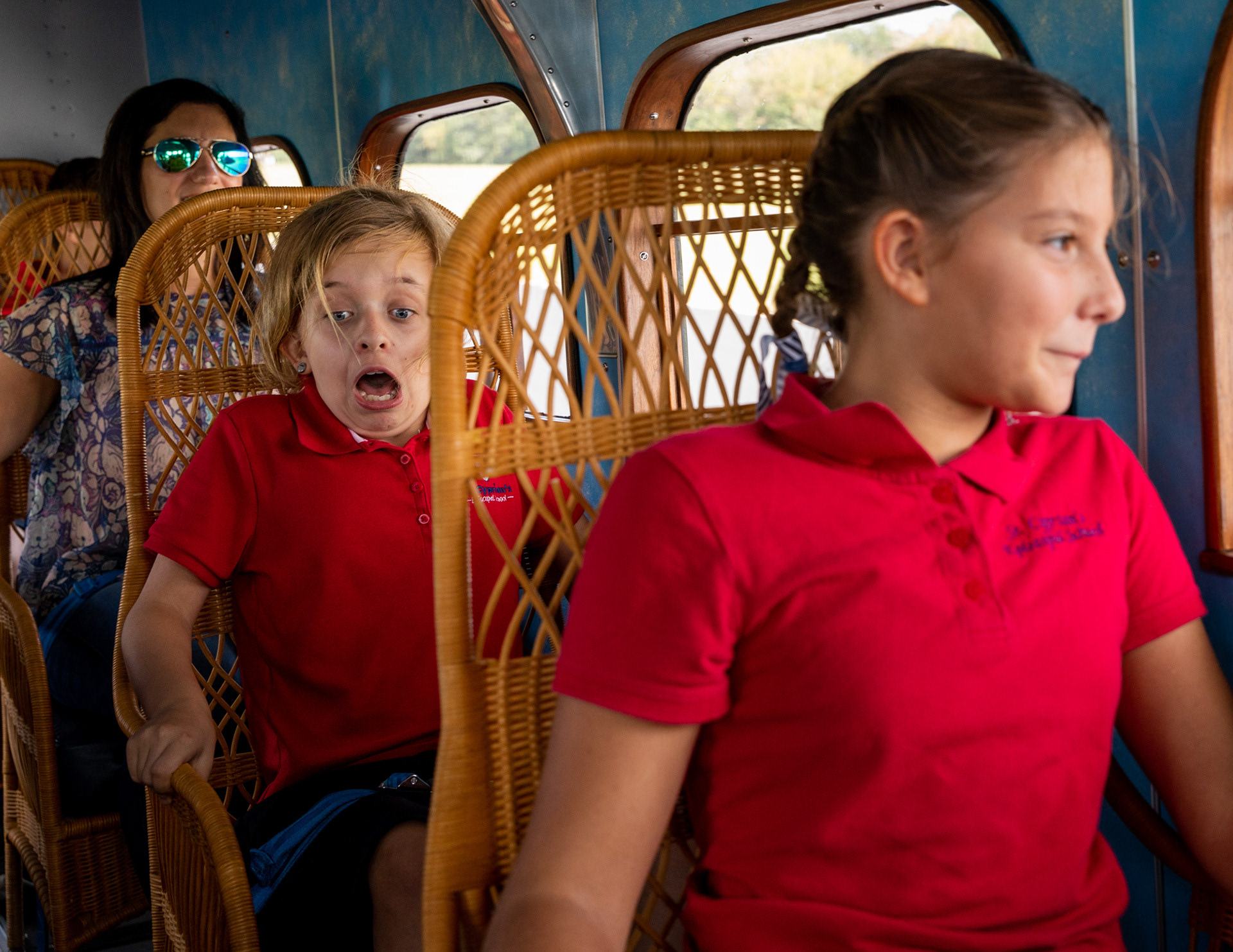St. Cyprian Episcopal School Fifth-grader Halle Devore, left, anxiously grips the arms of her whicker seat as Jenna Easley, right, with a smile, looks out the window during a flight in a 1928 Ford Trimotor airplane as it touches down on the tarmac Friday morning, October 7, 2018, at The Angelina County Airport in Lufkin, Texas. (Cara Campbell/The Lufkin Daily News)