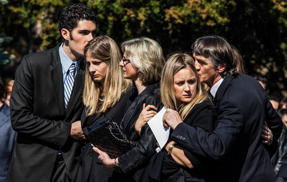 TORONTO, Ont. - (March 19, 2012) : Friends &amp; family of Nik Zoricic embrace following the young skier's funeral service at the Islington United Church. Zoricic, a member of the Canadian ski cross team, died from head injuries after an accident in Switzerland. Photo by Giordano Ciampini for Sun Media