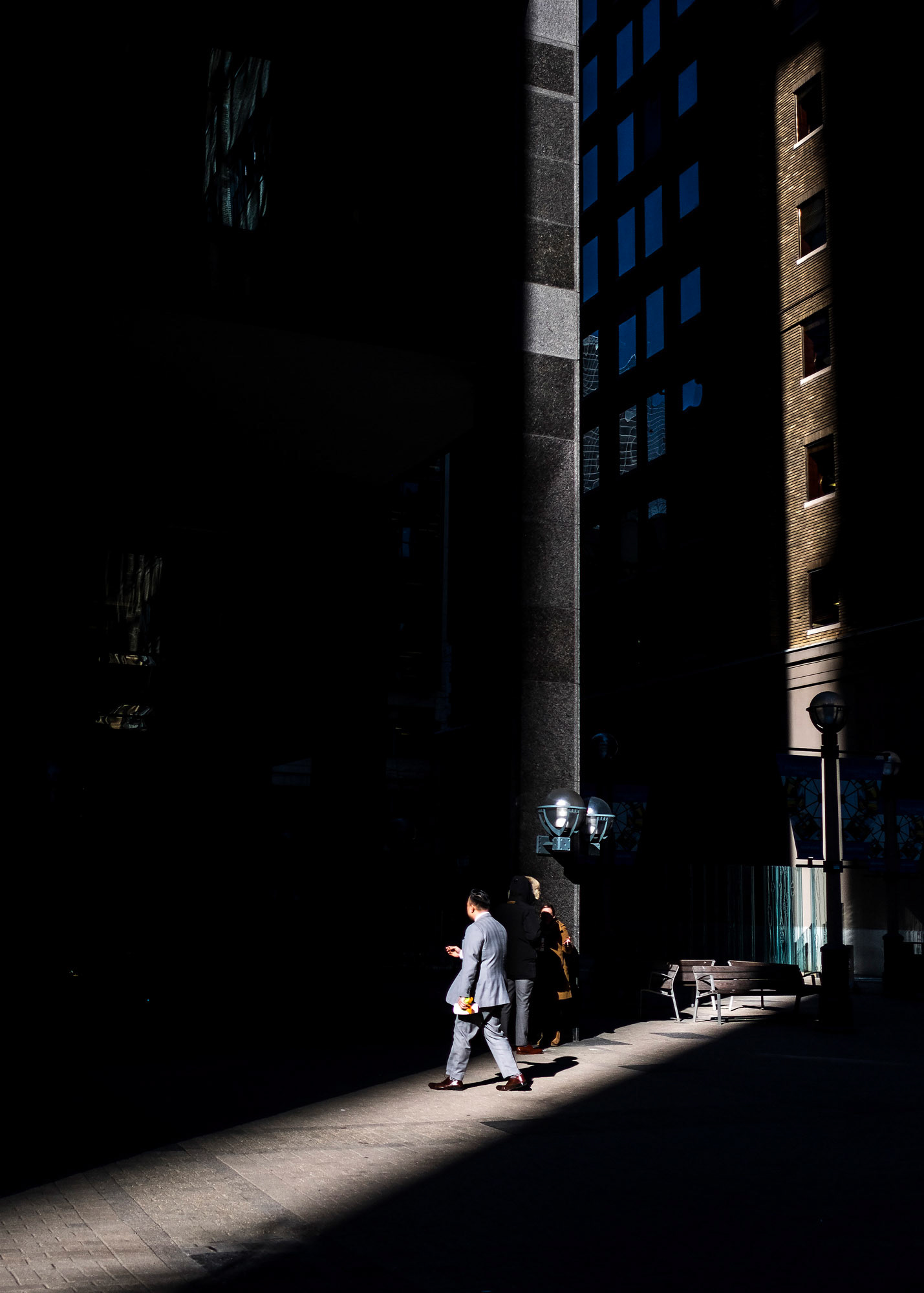 TORONTO -- A man walks through a shaft of light in Toronto's financial core on February 9, 2017.