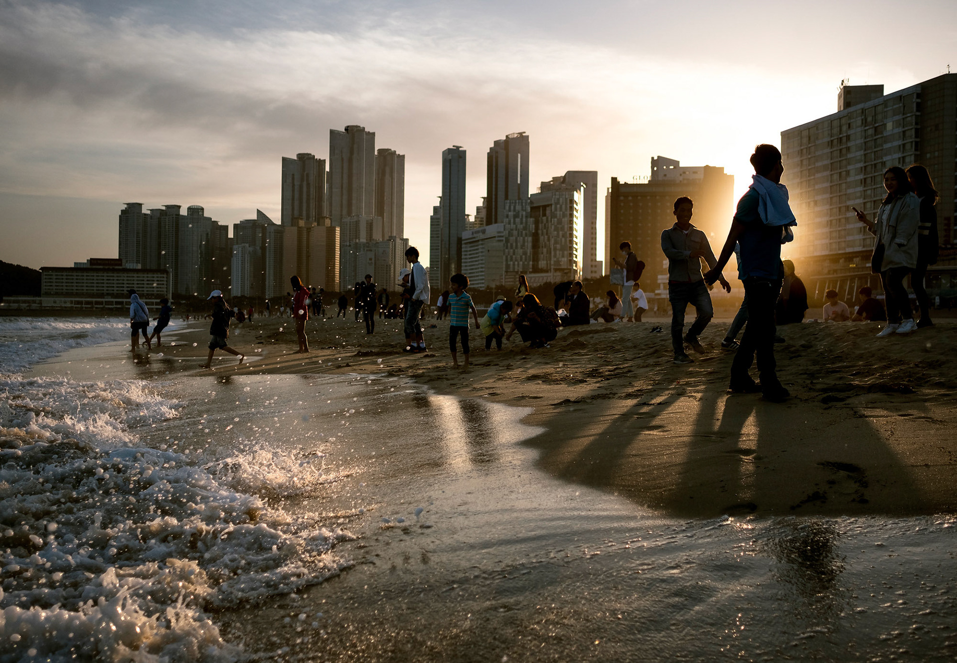 BUSAN, Rep. of Korea -- Young Koreans walk along Haeundae Beach at sunset, in Busan, Korea, on May 7, 2017.