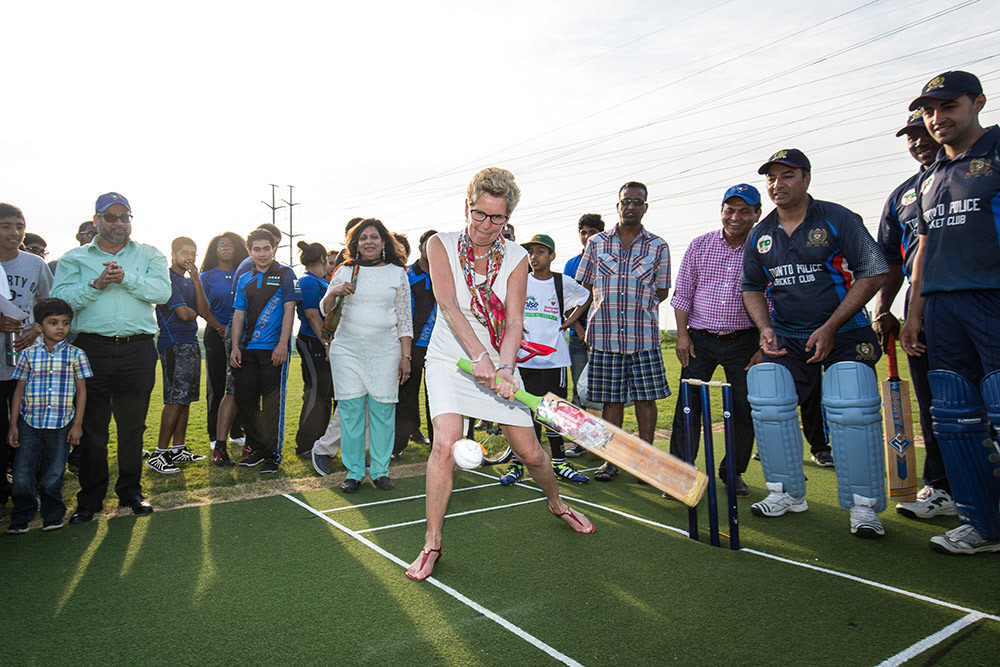 TORONTO, Ont. - Ontario Premier Kathleen Wynne swings her bat to try out on the cricket pitch at Valley park Middle School. Stakeholders, donors, players, locals and politicians all came out to celebrate the opening of the new Go Green Cricket and Sports Field at Valley Park Middle School in the Thorncliffe and Flemingdon Park areas. Photo by Giordano Ciampini