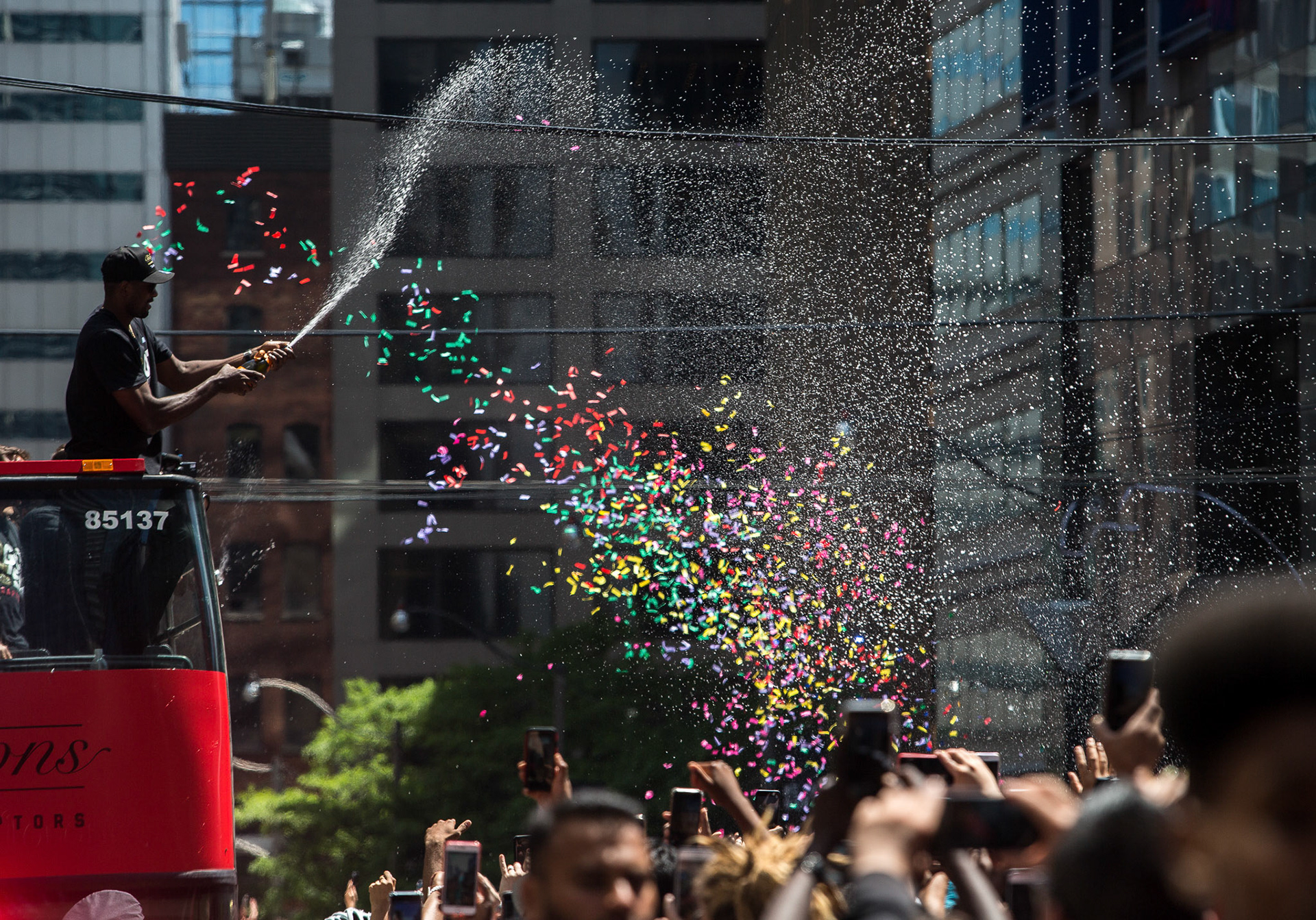 TORONTO--June 17, 2019 - The crowd gets sprayed with champagne by Serge Ibaka during the Toronto Raptors NBA championship victory parade.