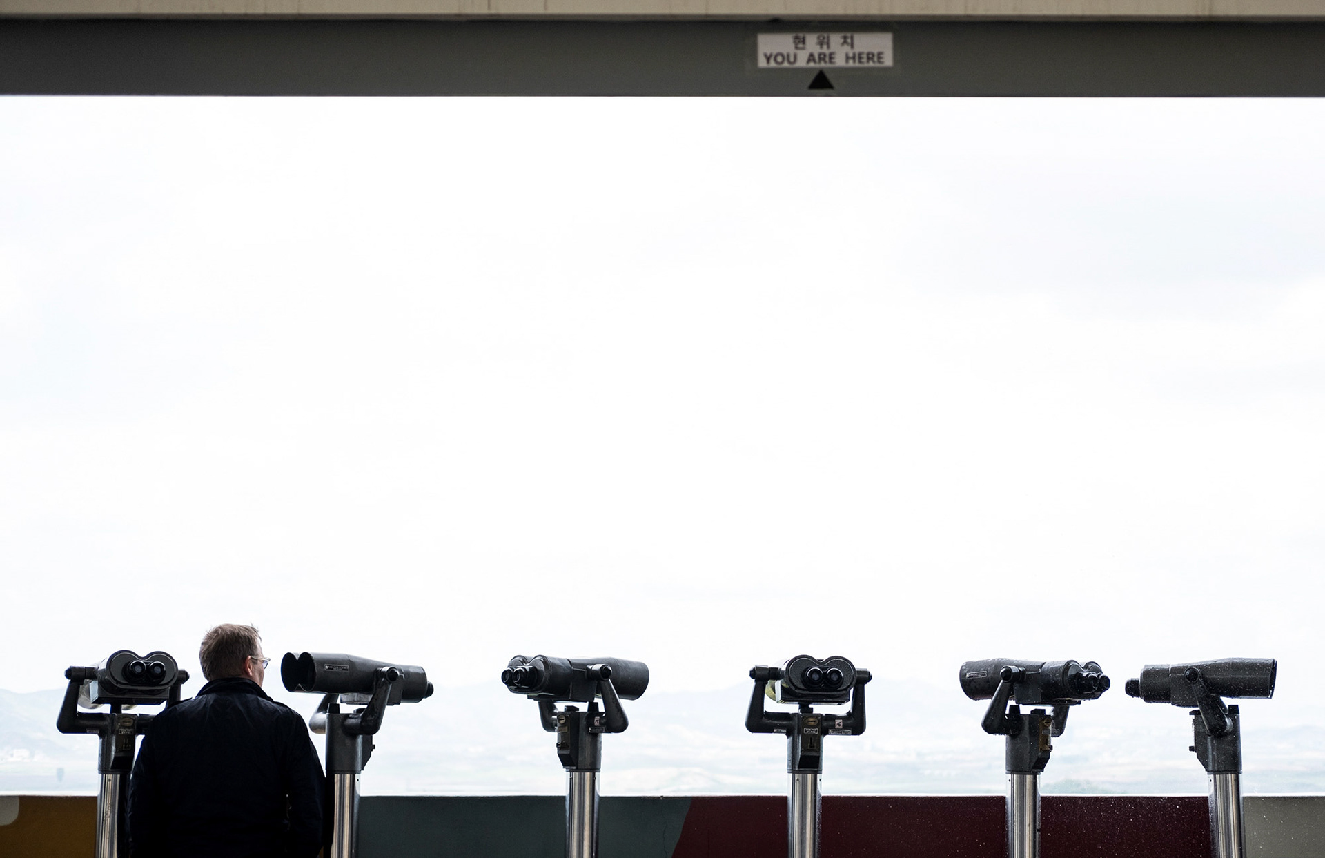 PAJU, Rep. of Korea -- A tourist looks out towards North Korea from the safety of the Dora Observatory, in Paju, Korea, on May 4, 2017. Dora Observatory is a location which offers the closest viewing point of the border of the two Koreas without a specially-granted permit.