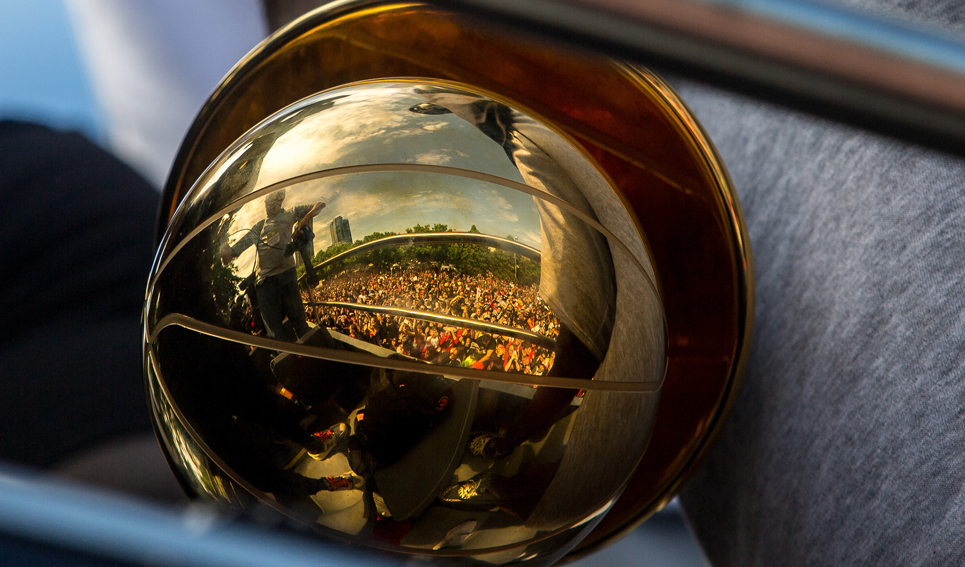 TORONTO--June 17, 2019 - The crowd is reflected in the Larry O'Brien trophy, held by Kawhi Leonard during the Toronto Raptors NBA championship victory parade.