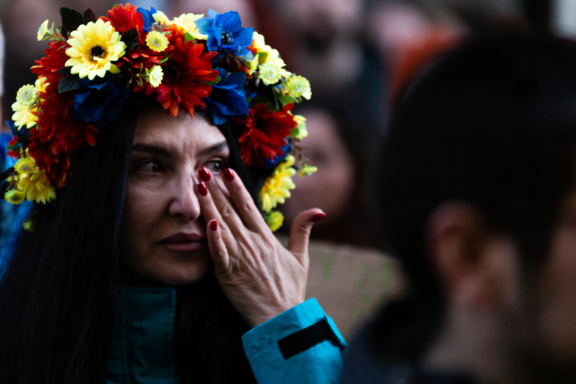 A Ukrainian woman is seen crying during the demonstration. Thousands of people marched on the streets of eleven cities in Portugal to support Ukraine, as it marks one year of Russia's invasion. In Porto, the concentration was made at the Coliseum, followed by a march to the City Hall.